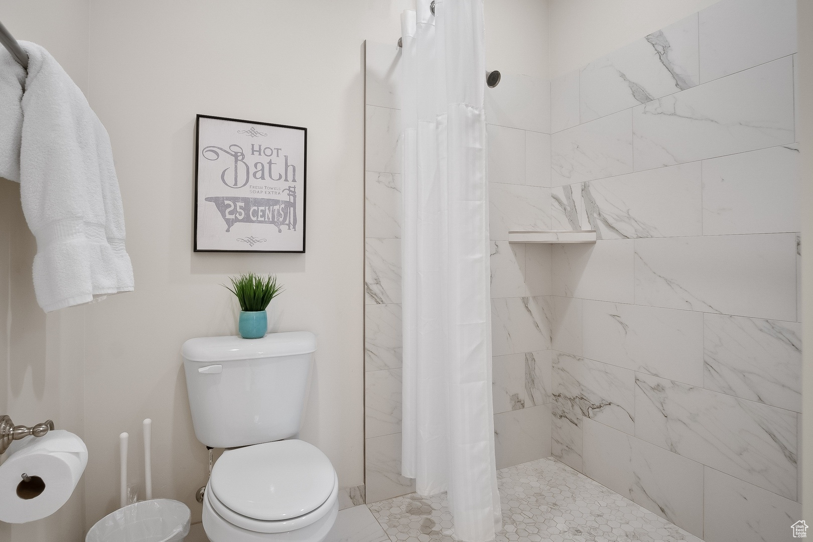 Bathroom featuring curtained shower and toilet