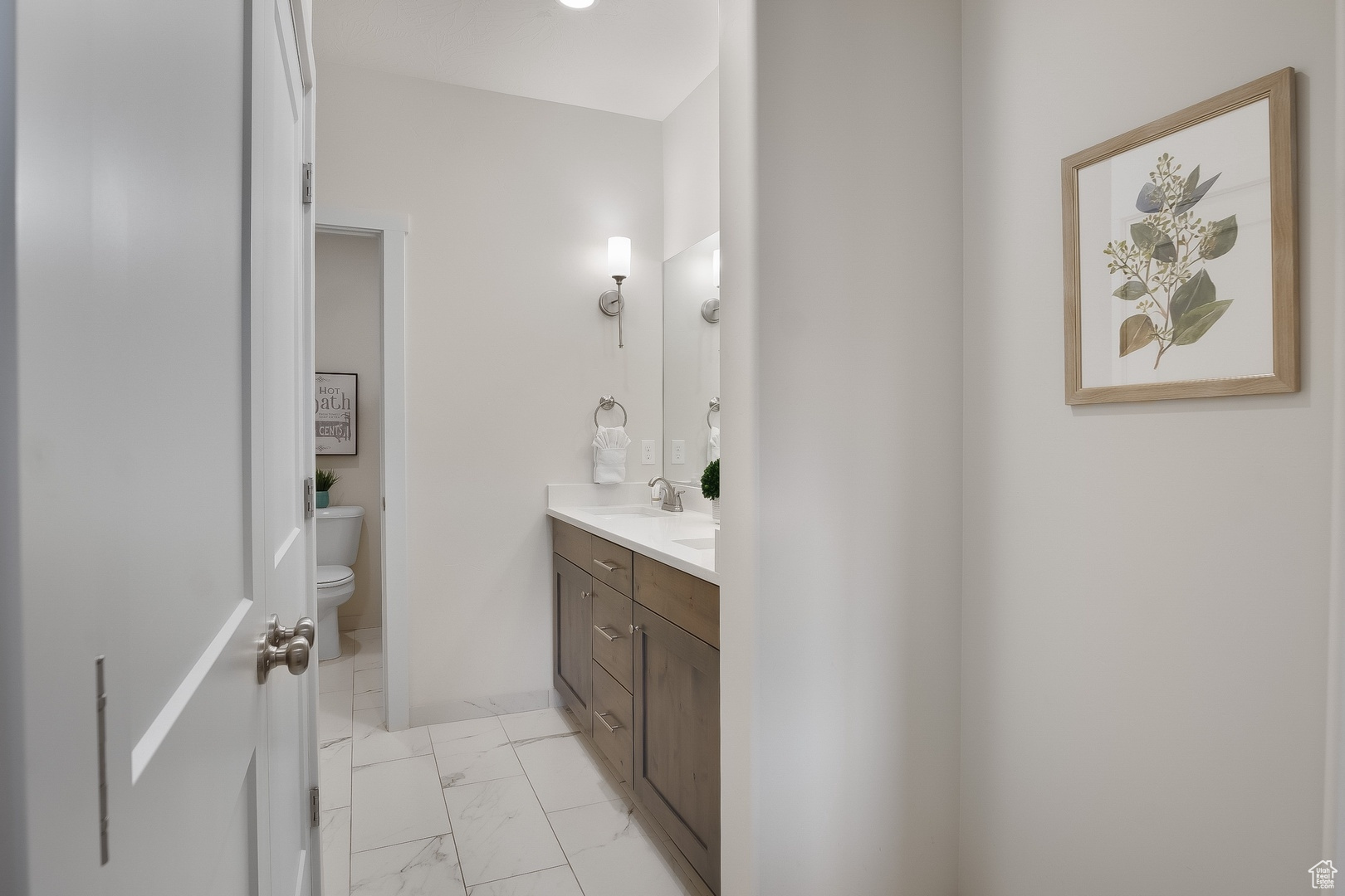 Bathroom with tile flooring, vanity, and toilet