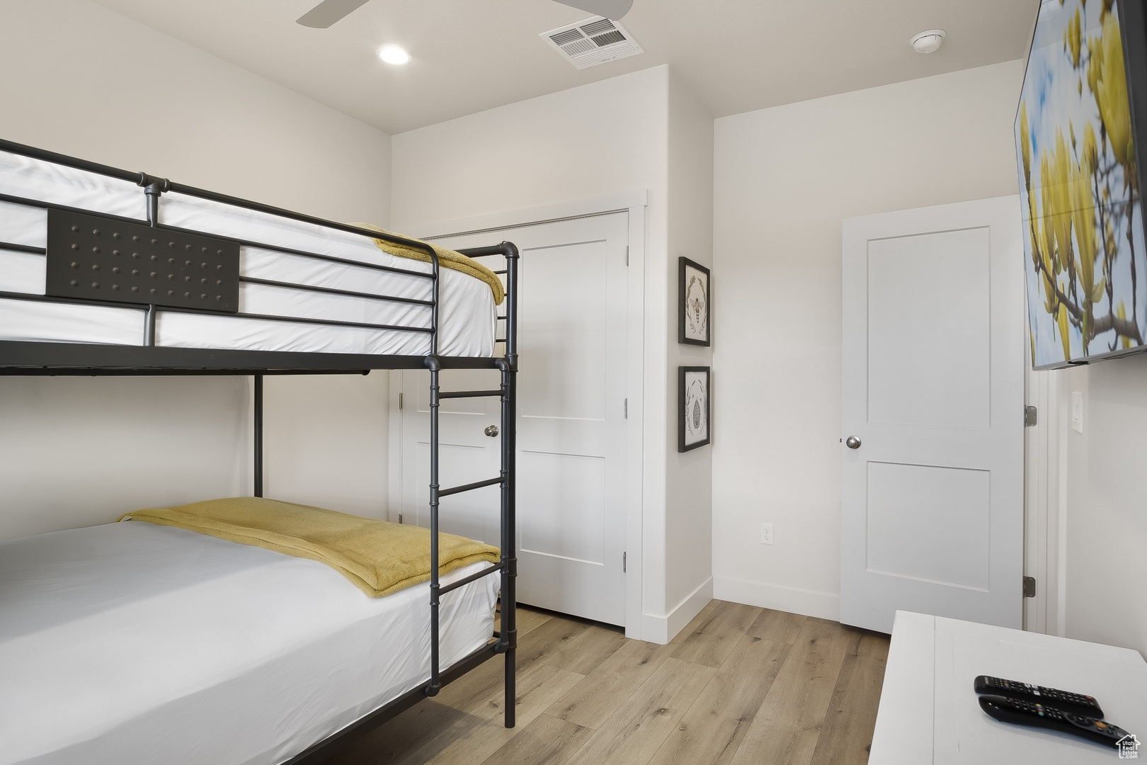 Bedroom featuring ceiling fan and light wood-type flooring