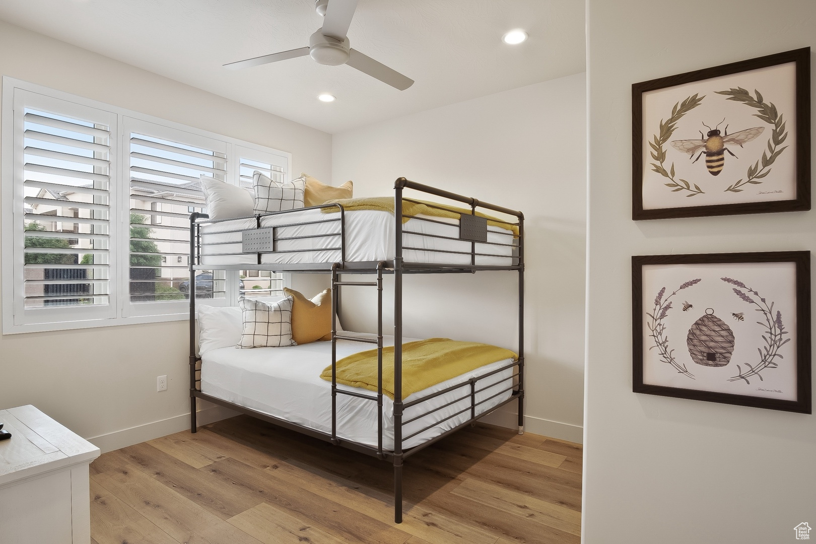 Bedroom featuring light hardwood / wood-style floors and ceiling fan