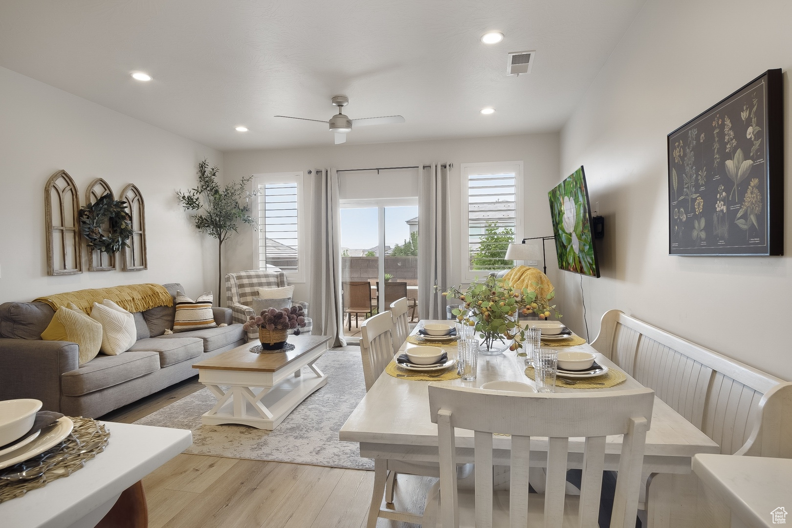 Living room featuring ceiling fan, light wood-type flooring, and radiator