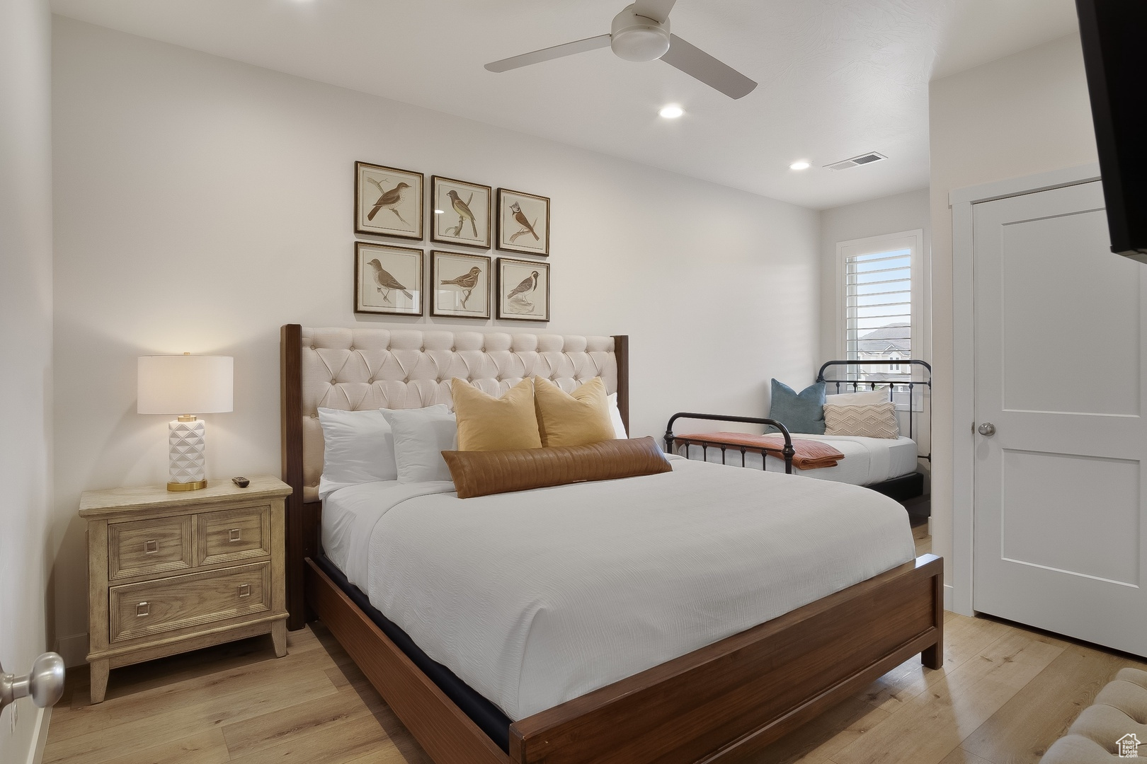 Bedroom featuring light hardwood / wood-style flooring and ceiling fan