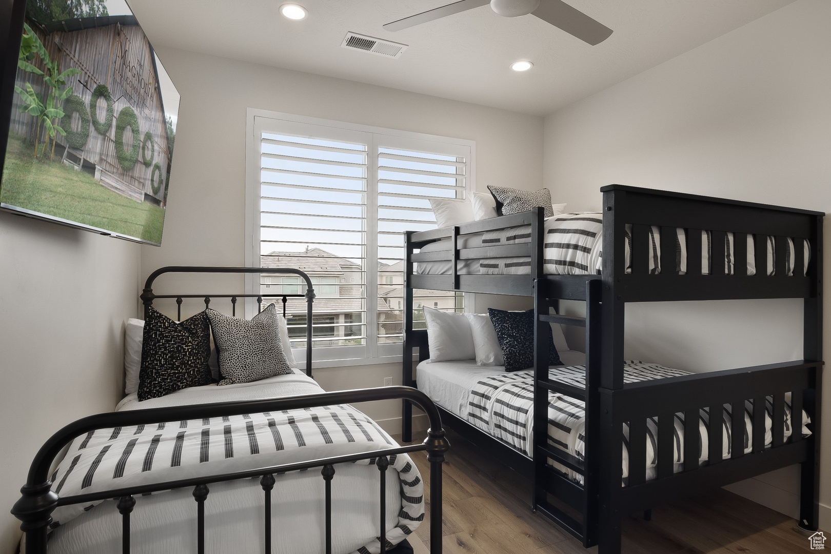 Bedroom with ceiling fan and hardwood / wood-style flooring