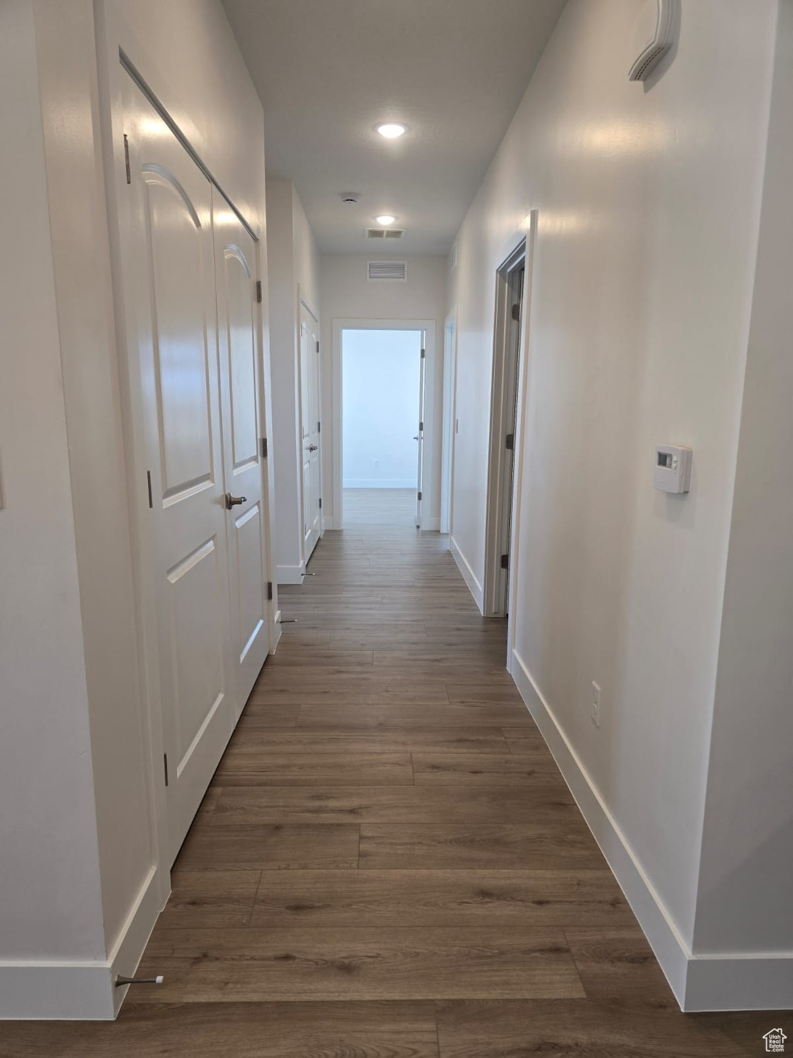 Hall featuring  continuous LVP flooring.