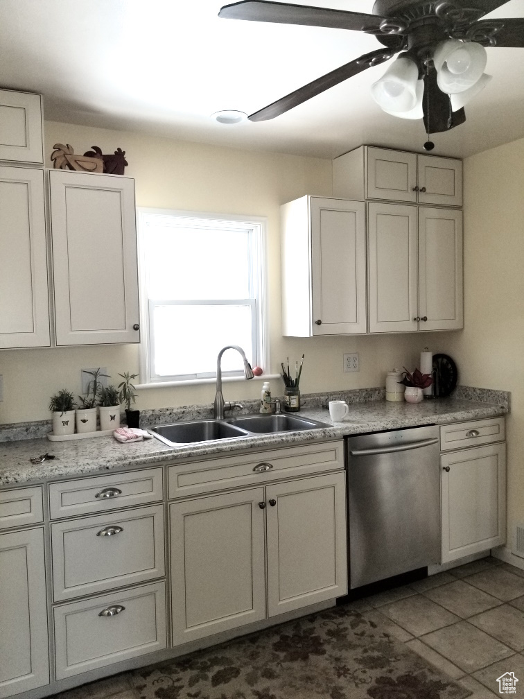 Kitchen with ceiling fan, white cabinetry, dishwasher, sink, and tile floors