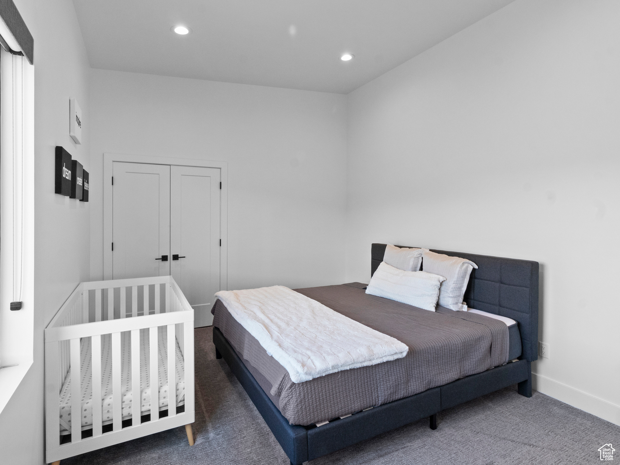 Bedroom with a closet and dark carpet