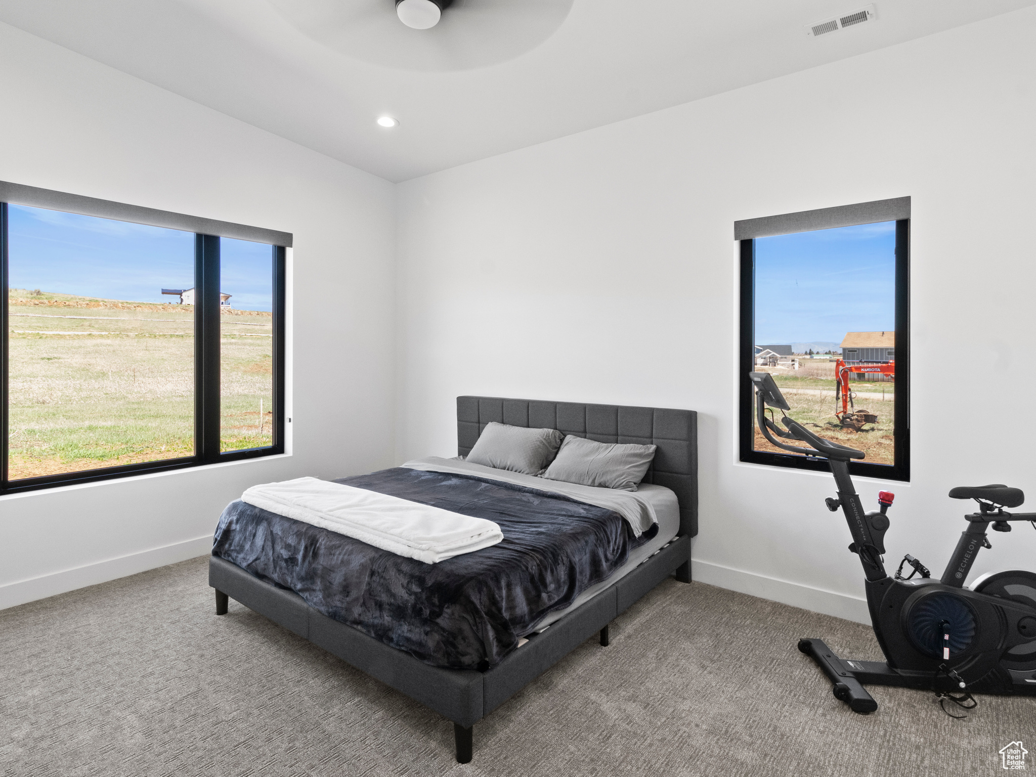 Carpeted bedroom featuring ceiling fan