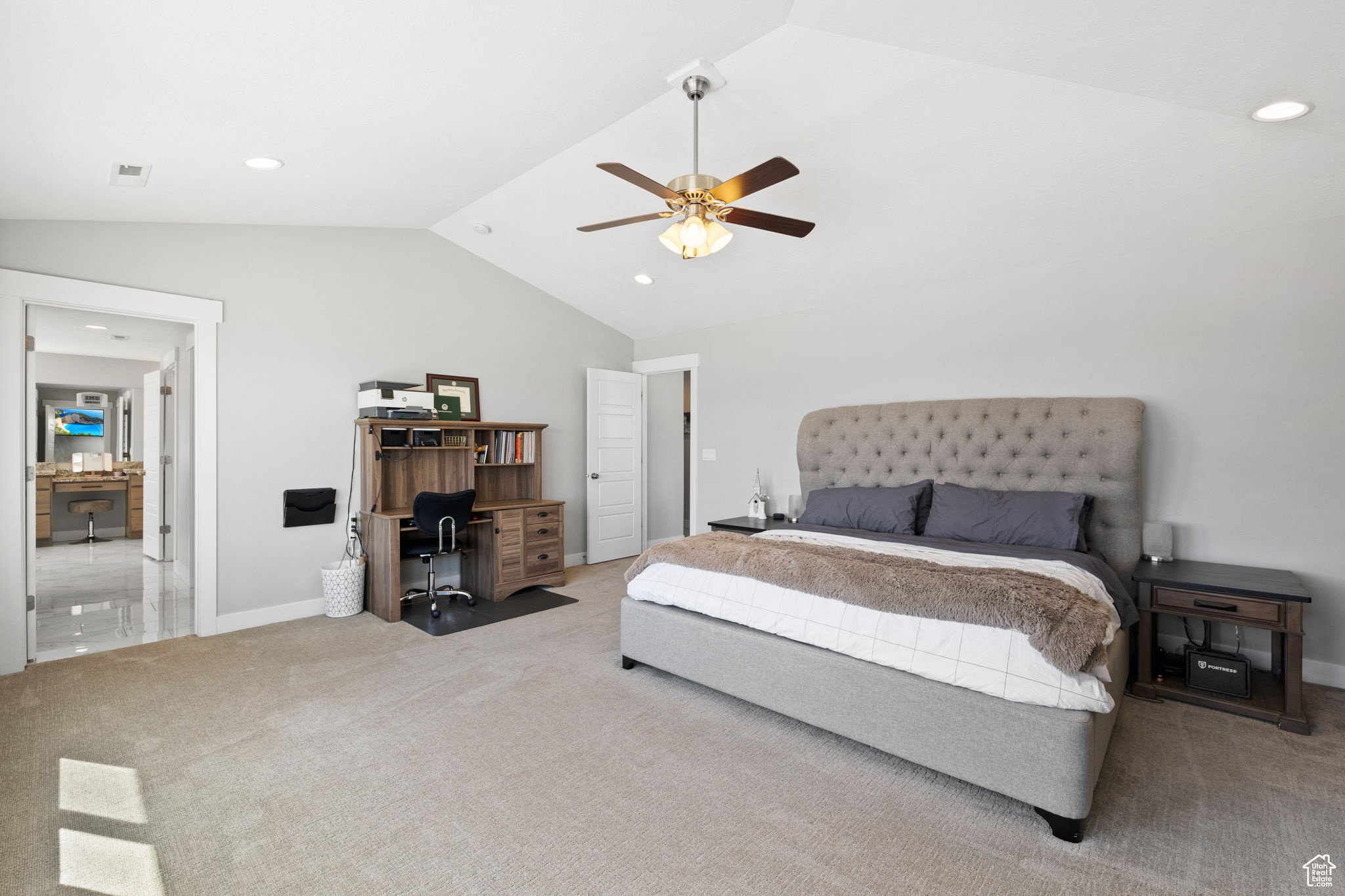 Bedroom with light carpet, ceiling fan, and lofted ceiling
