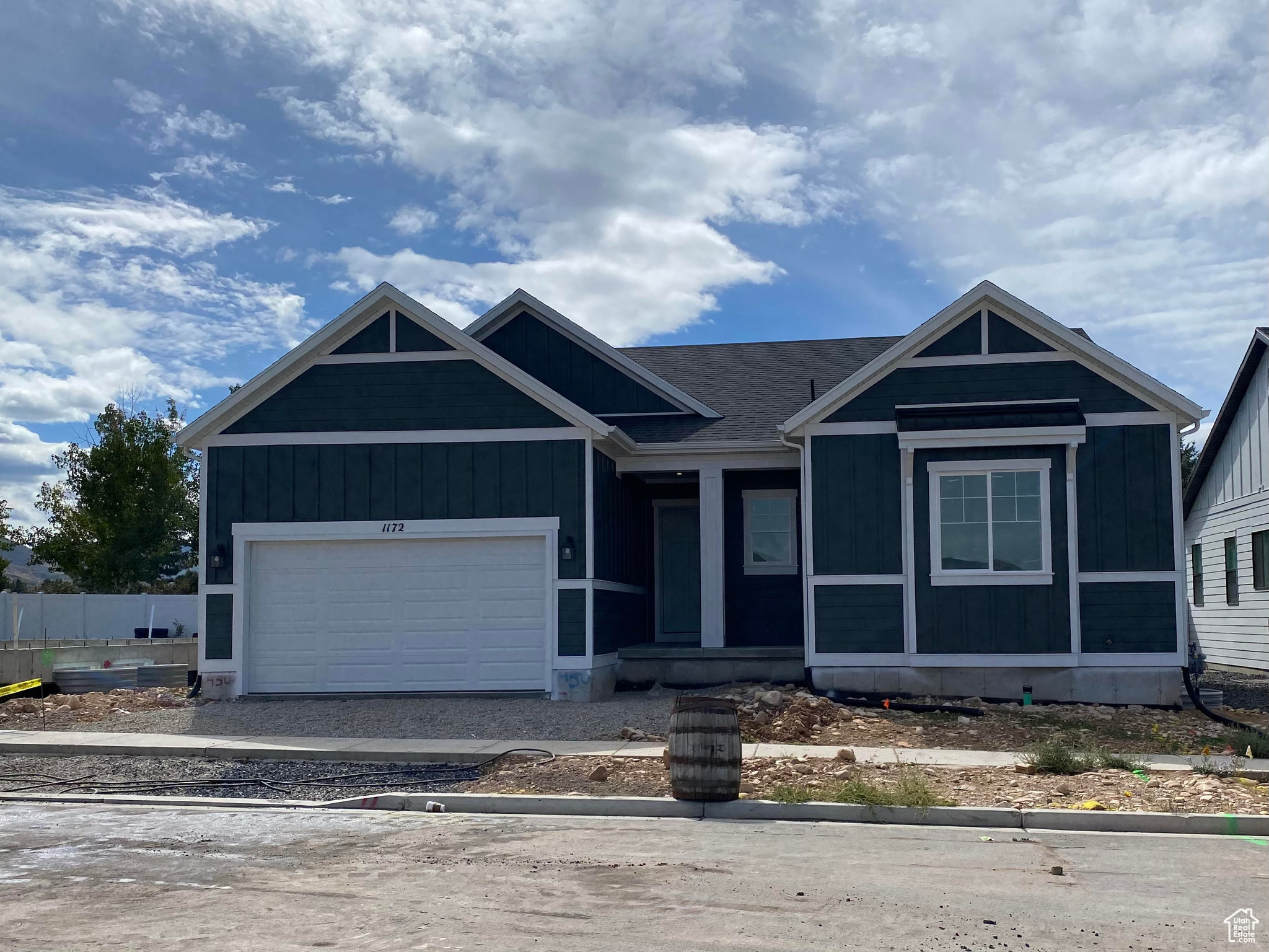 View of front of property featuring a garage and covered porch