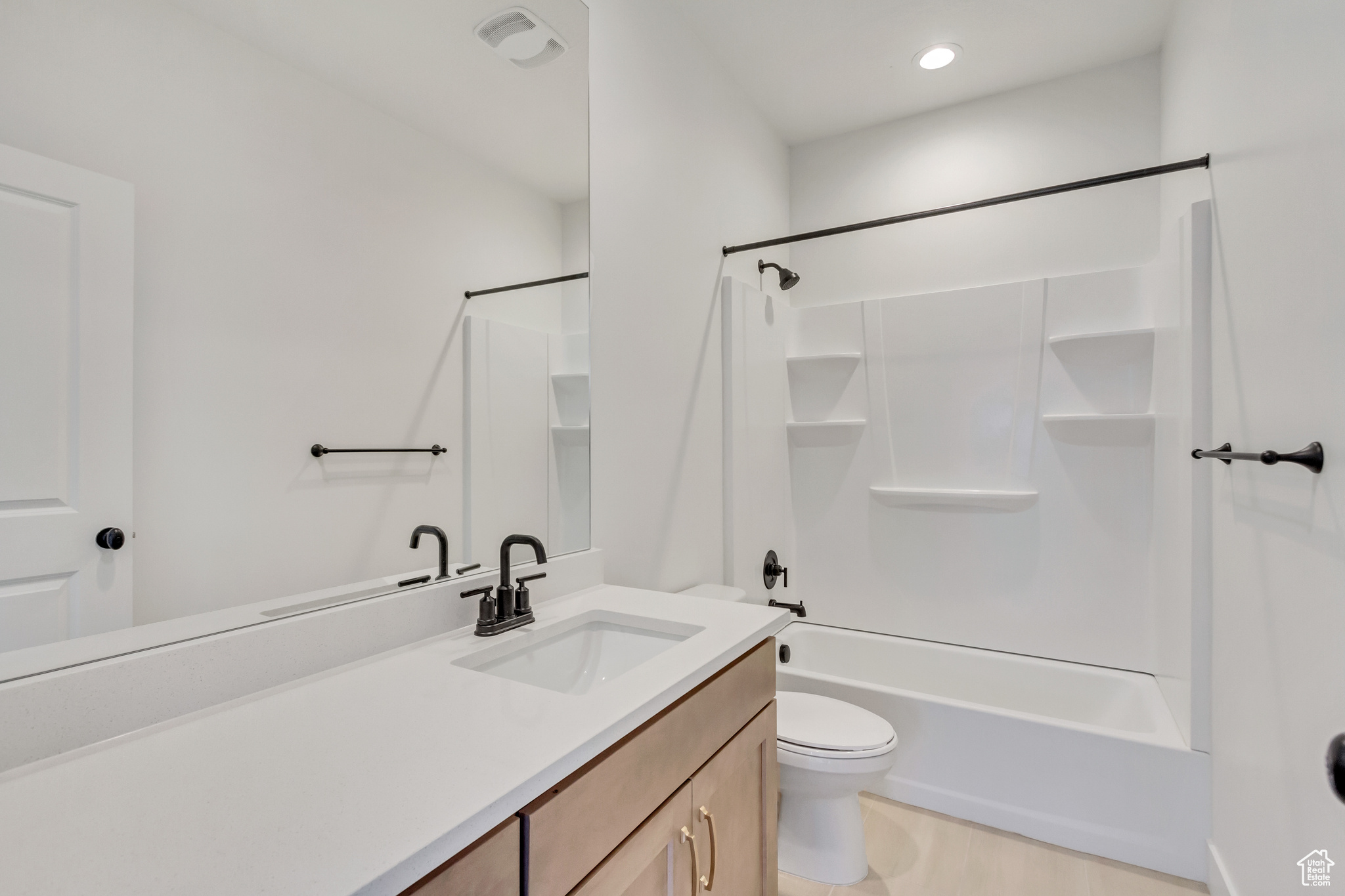 Full bathroom with vanity, toilet, and shower / washtub combination