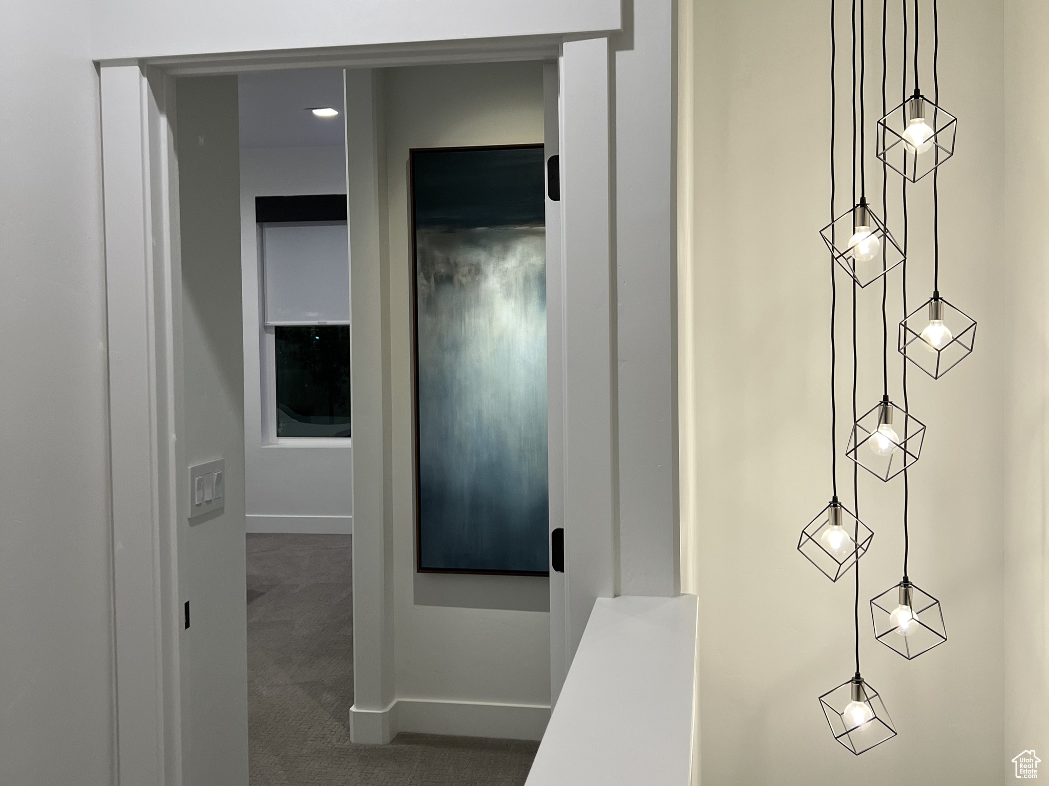 Stairway chandelier and entry to primary bedroom