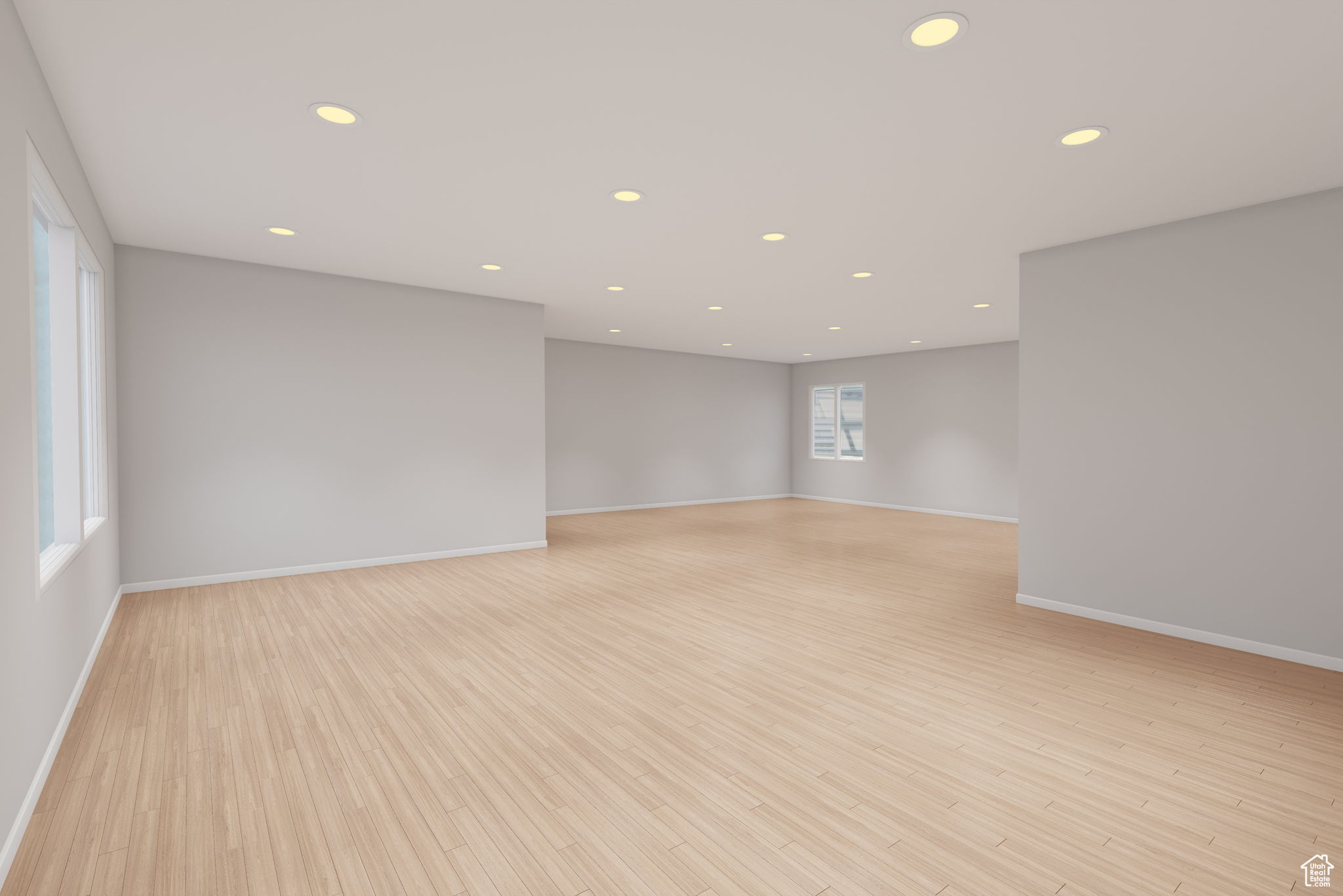 VIRTUALLY STAGED TO SHOW POTENTIAL unfurnished basement room featuring light hardwood / wood-style floors