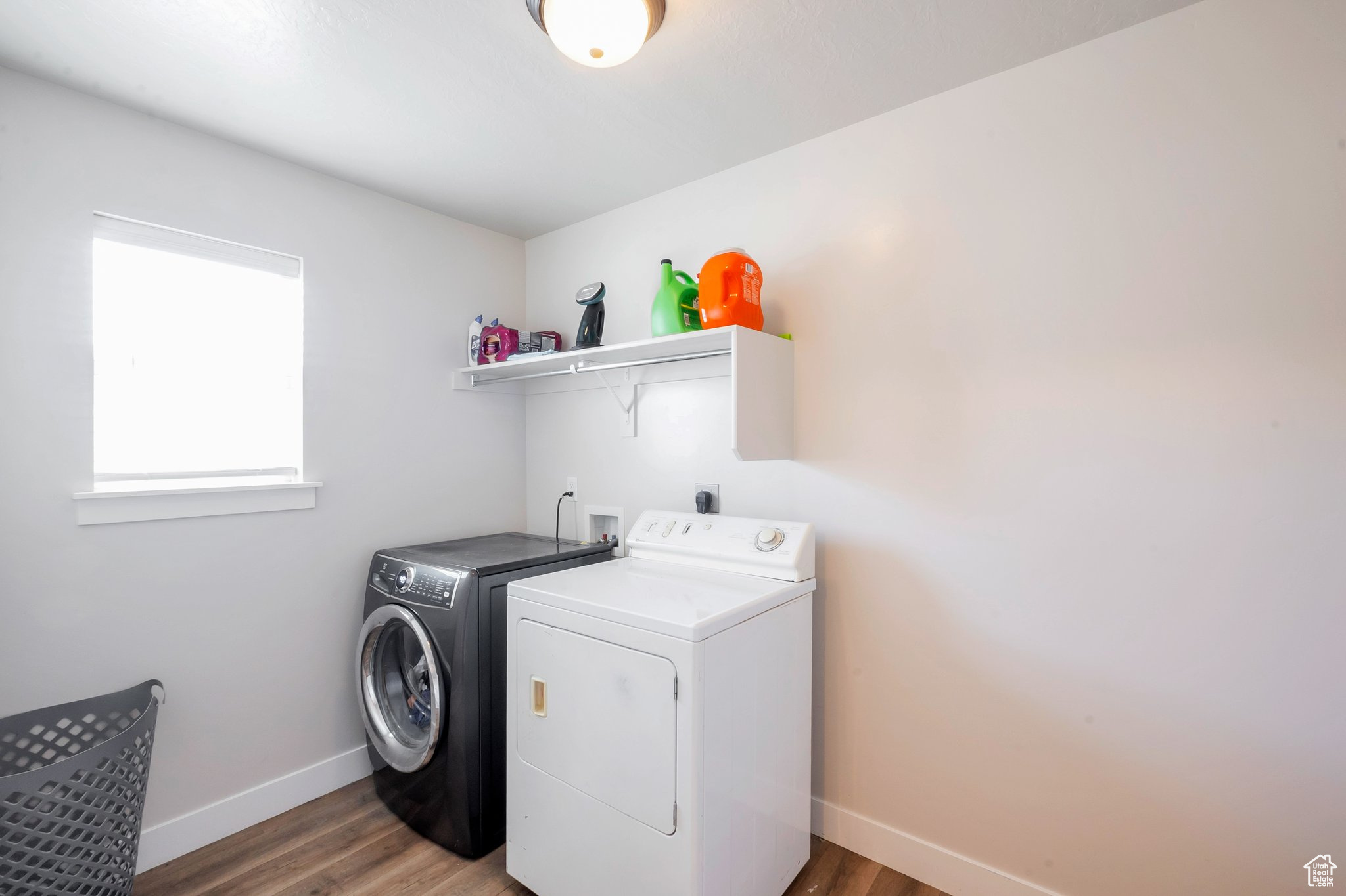 Washroom featuring hardwood / wood-style flooring, hookup for a washing machine, and separate washer and dryer