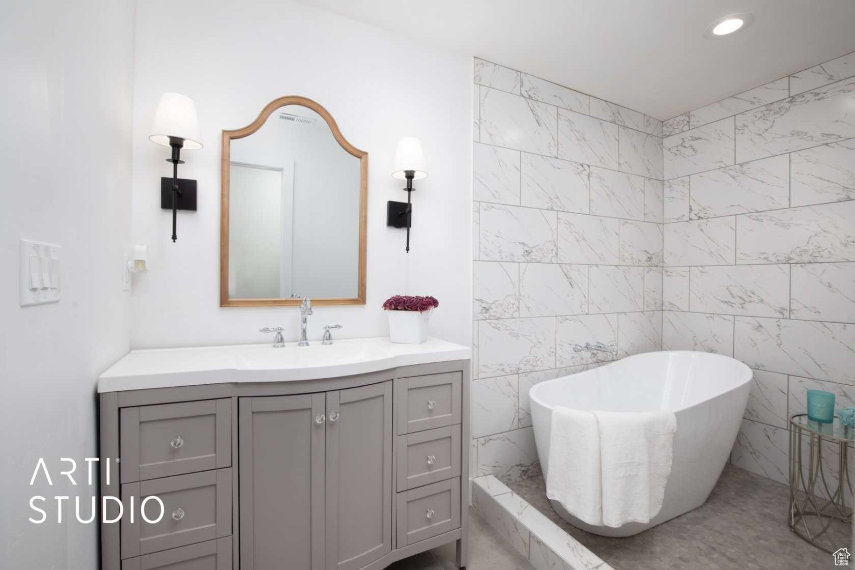 Bathroom featuring oversized vanity, tile walls, and a soaking tub in a large wetroom