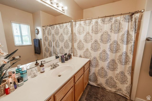 Bathroom featuring vanity with extensive cabinet space