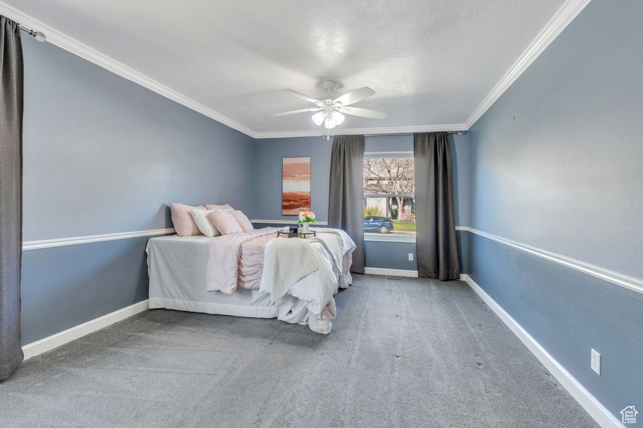 Bedroom featuring ceiling fan, carpet, and ornamental molding