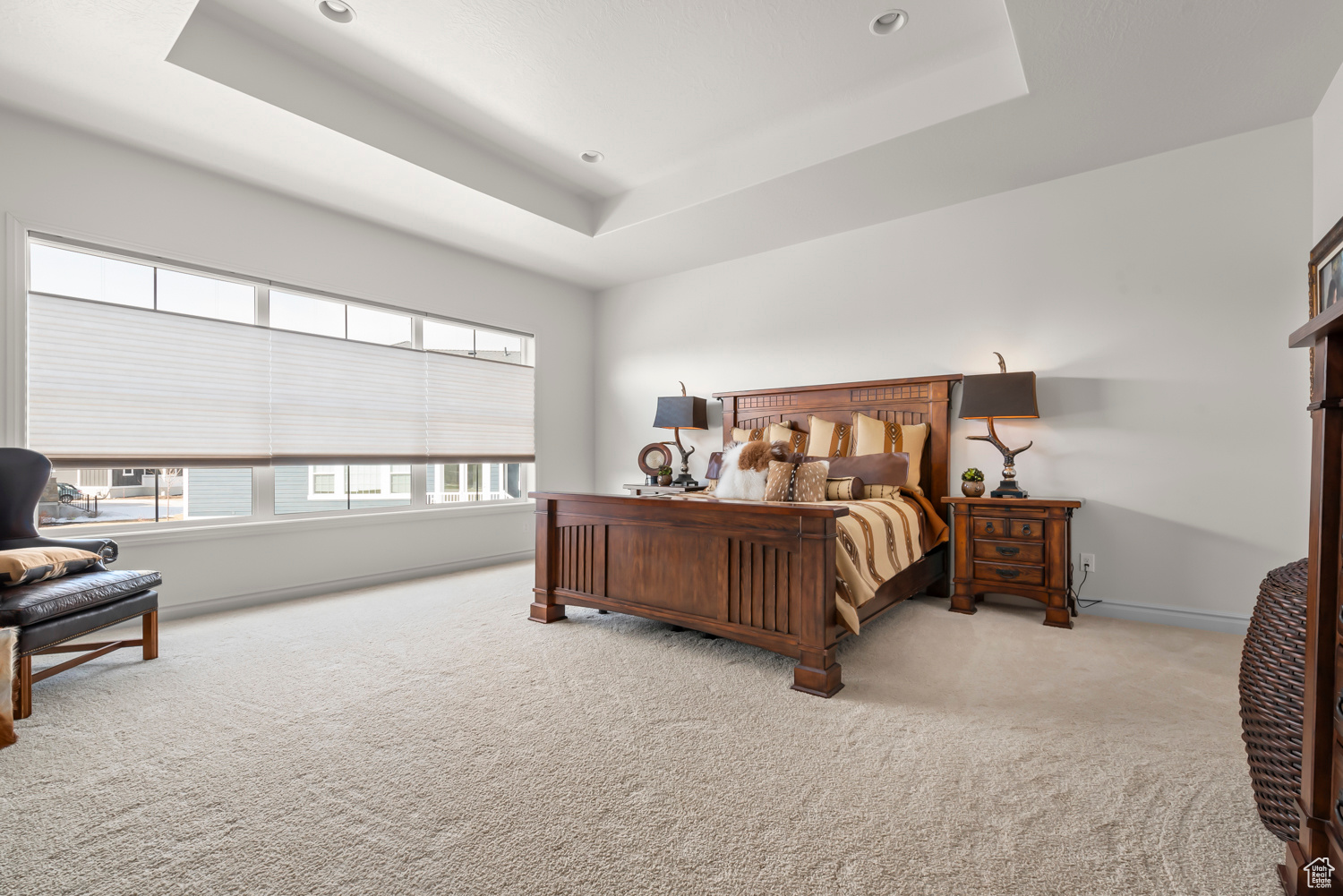 Spacious Owner's Suite with plush new Maslad carpet, coffered ceiling, remote controlled shades by Summit Shutters