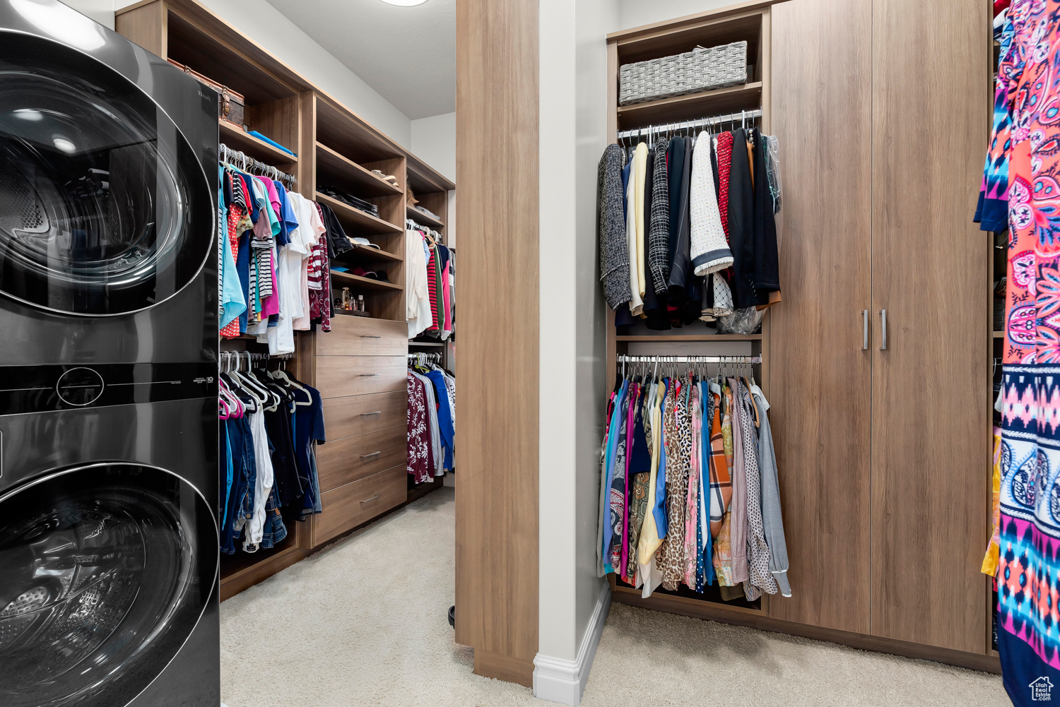 Owner's Suite Spacious closet with light carpet and optional stackable washer and dryer. Custom designed by Closet Butler