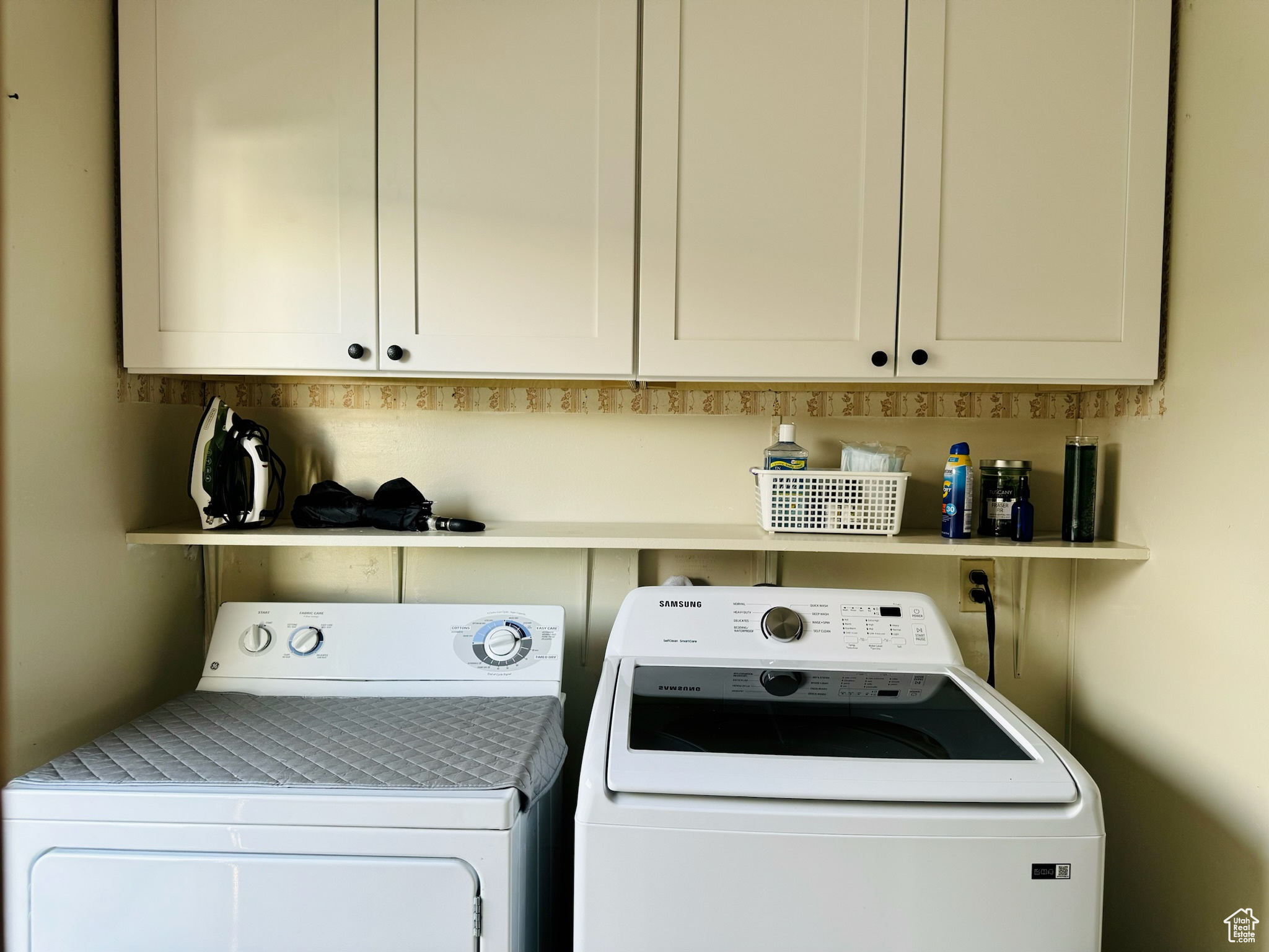 Clothes washing area with washing machine and dryer and cabinets