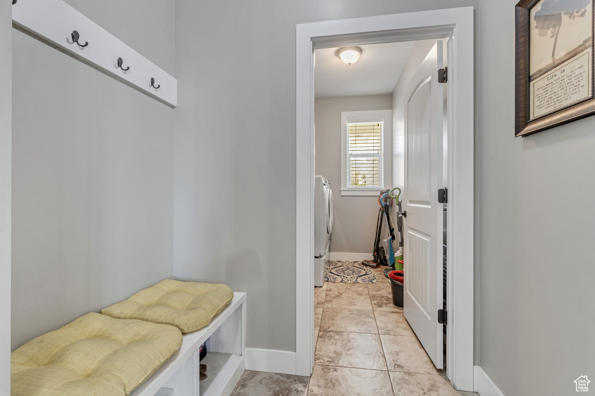 Mudroom featuring light tile floors and washer / dryer