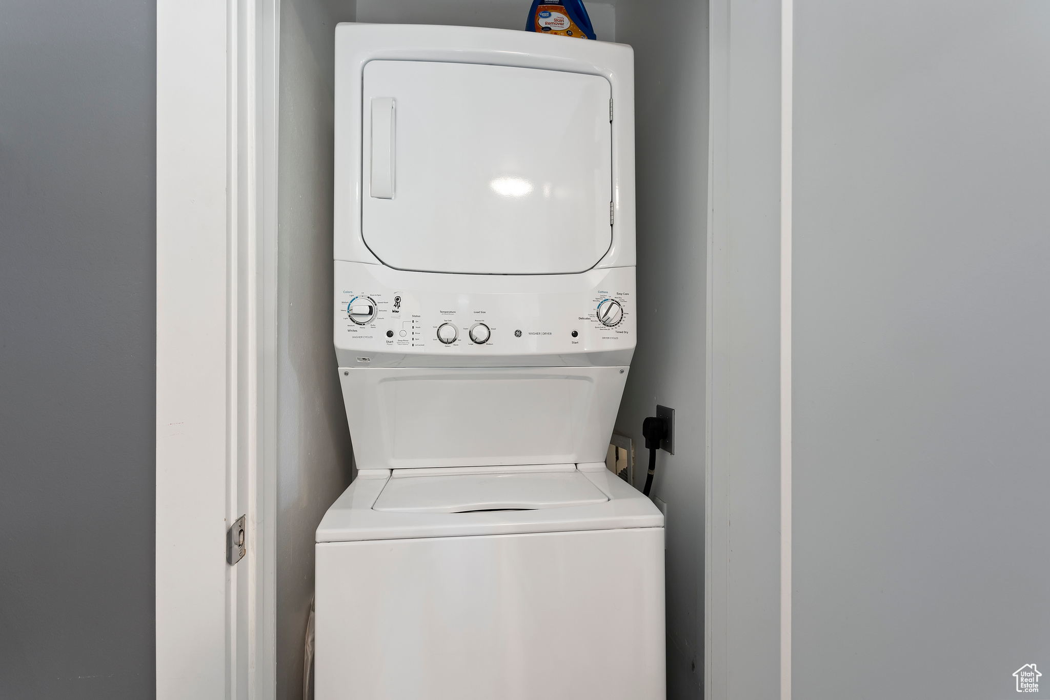 Laundry room featuring stacked washer / dryer and electric dryer hookup