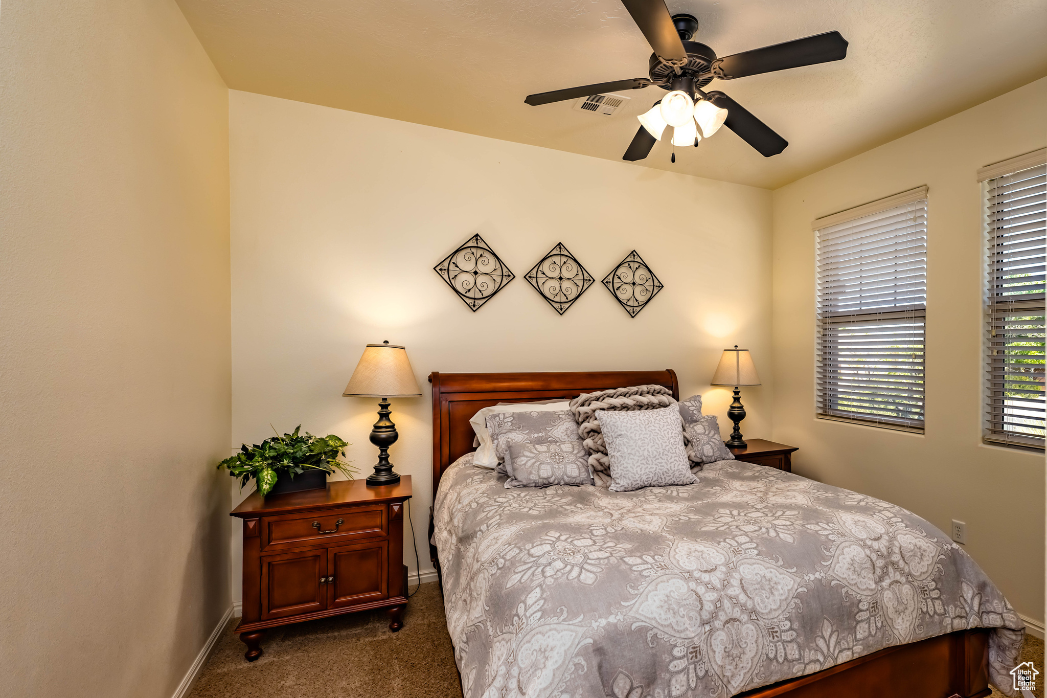 Carpeted bedroom 2 featuring ceiling fan