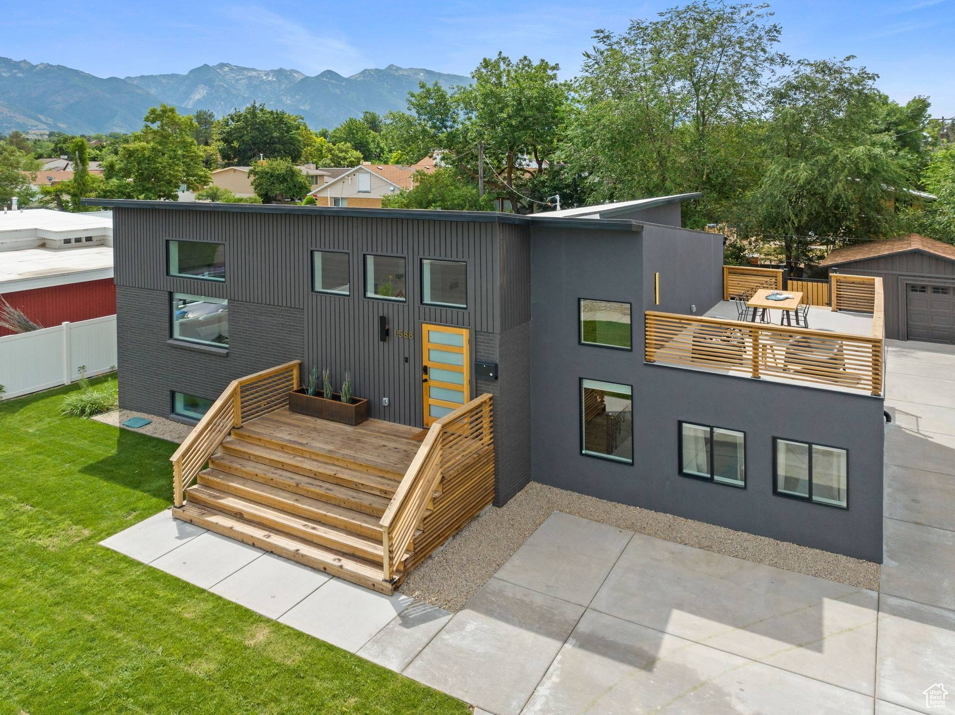 Modern home with large yard, roof top deck, and a mountain view