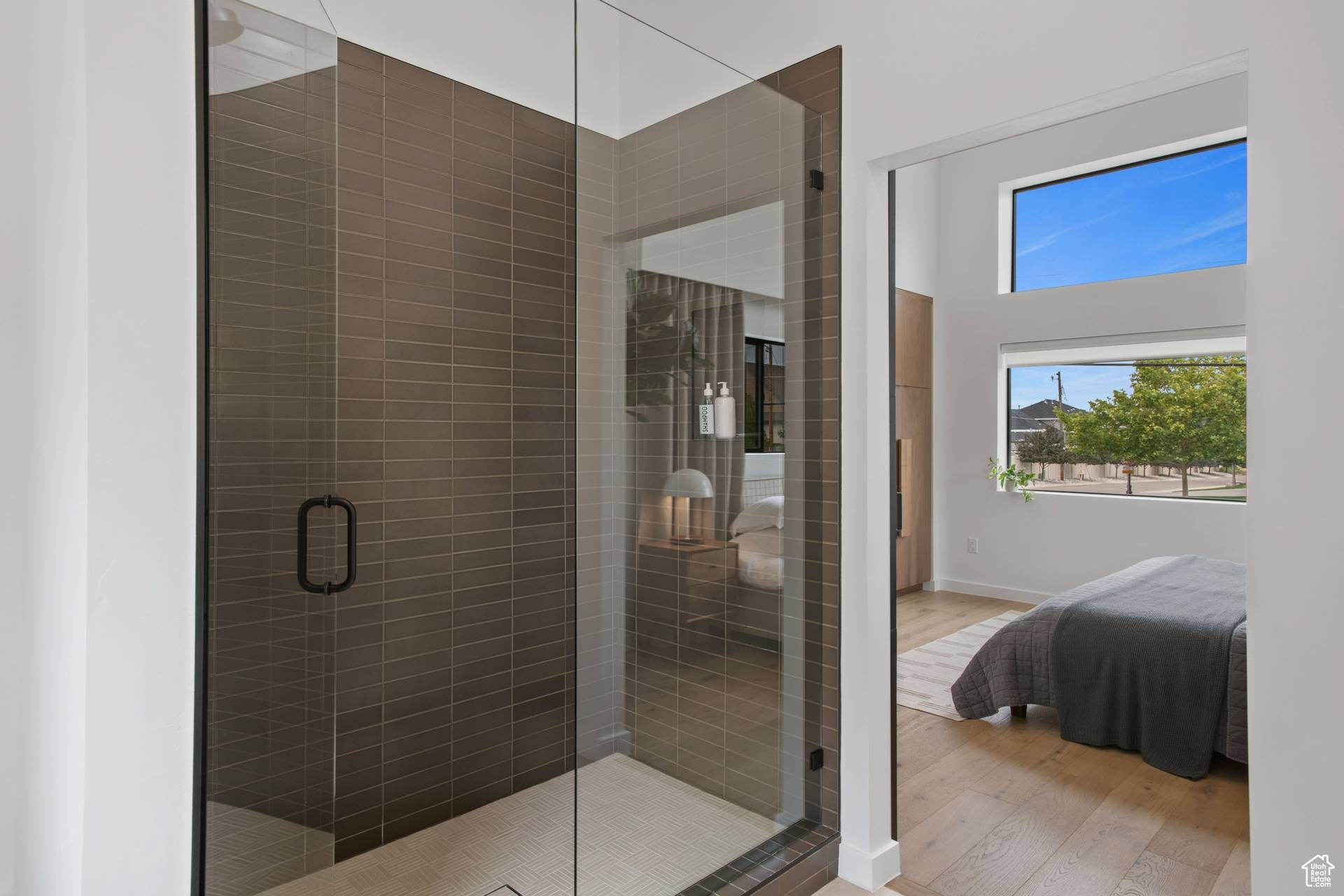 Bathroom with walk in shower and hardwood / wood-style flooring