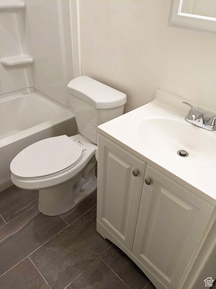 Full bathroom featuring tile flooring, shower / bathtub combination, vanity, and toilet