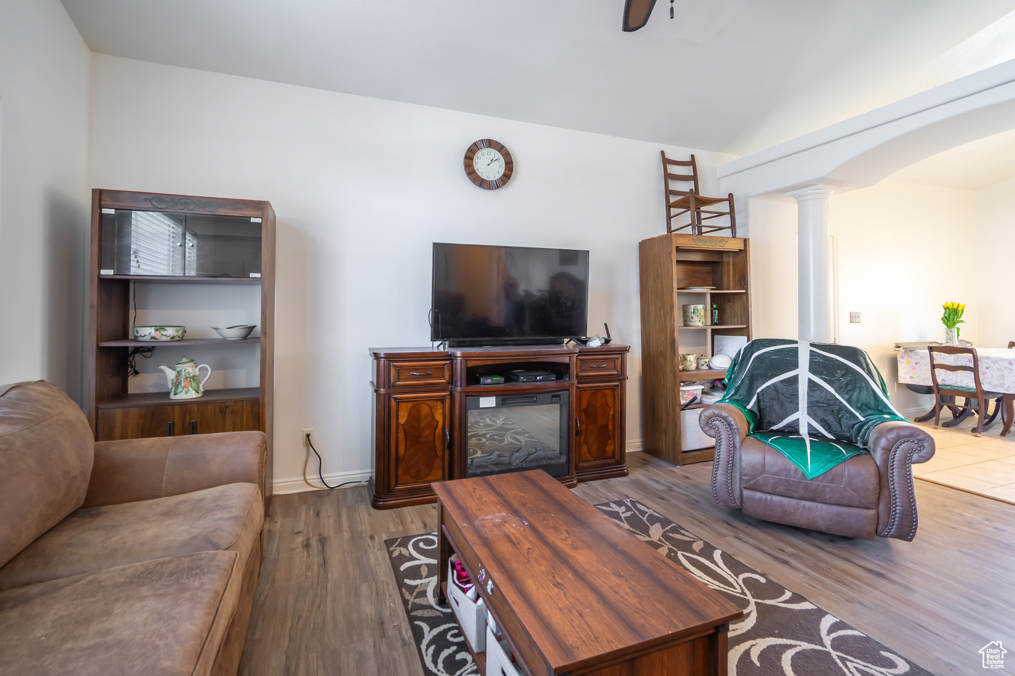 Living room featuring dark hardwood / wood-style floors and decorative columns