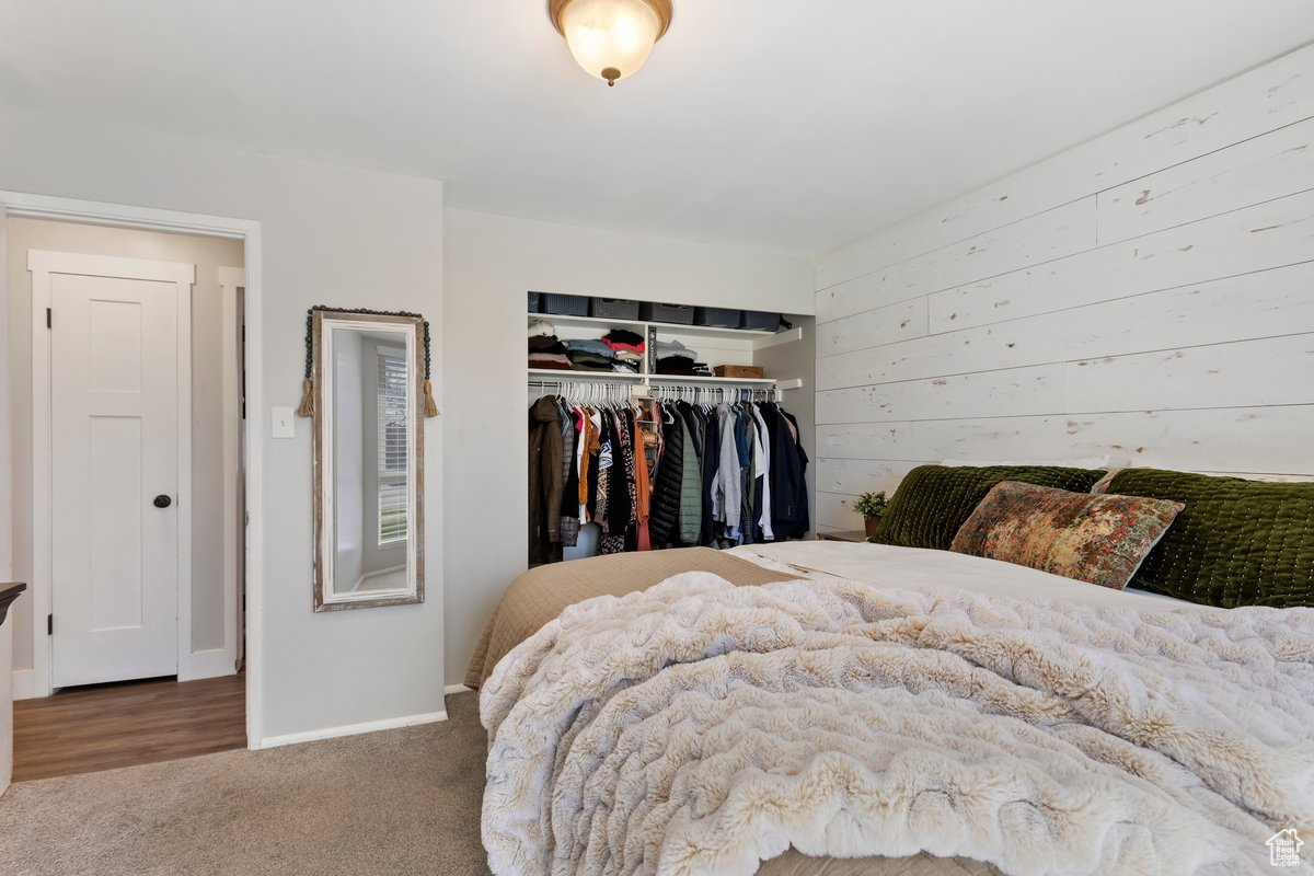 Bedroom featuring a closet and dark carpet