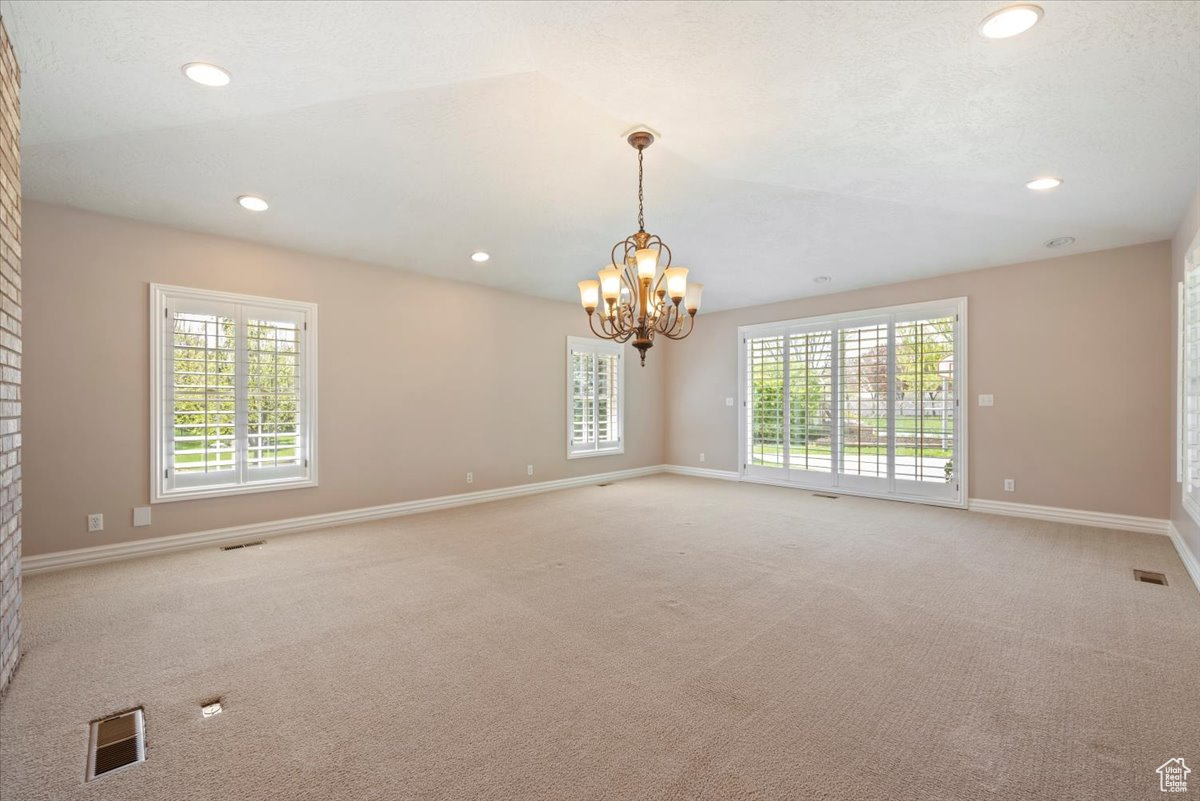 Formal Dining room featuring light colored carpet and a chandelier