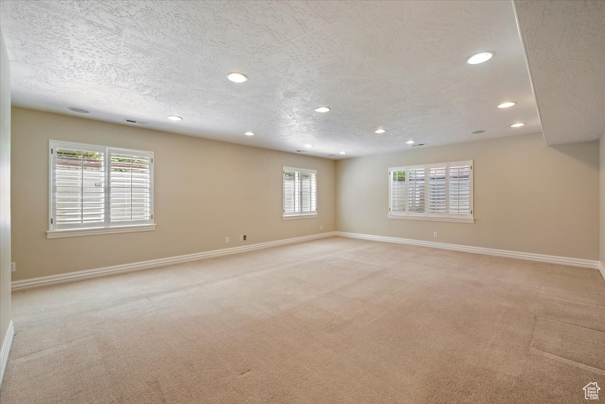 Family room with a textured ceiling and light carpet
