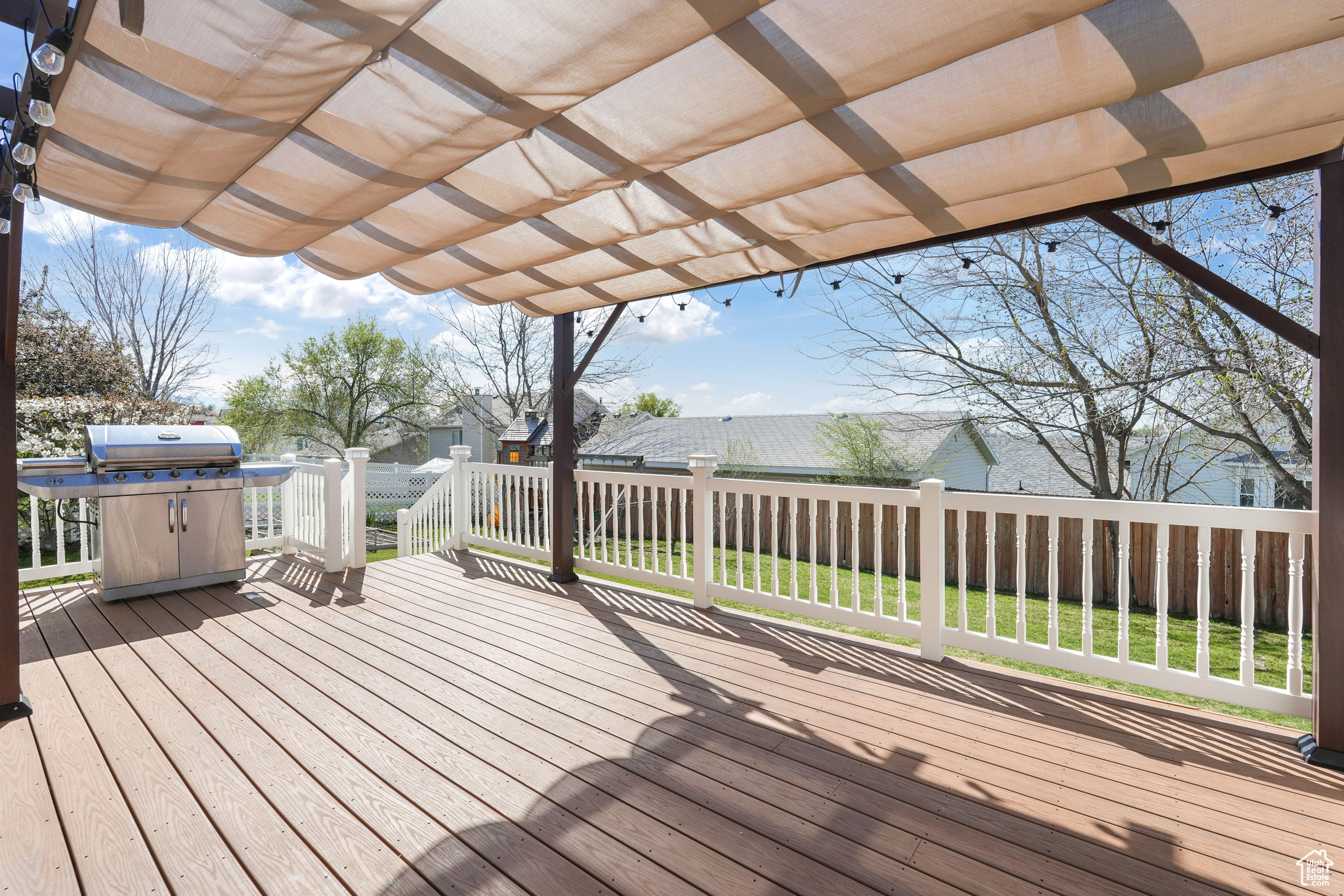 Wooden terrace featuring a yard, a pergola, and grilling area