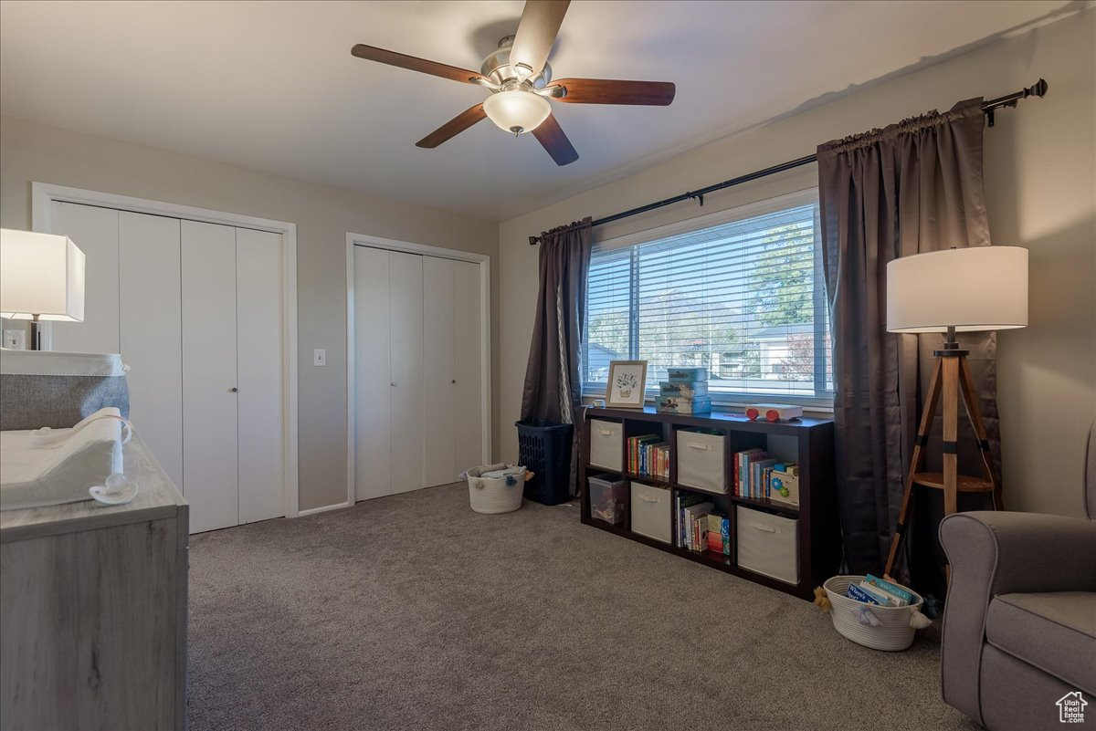 Interior space with carpet and ceiling fan