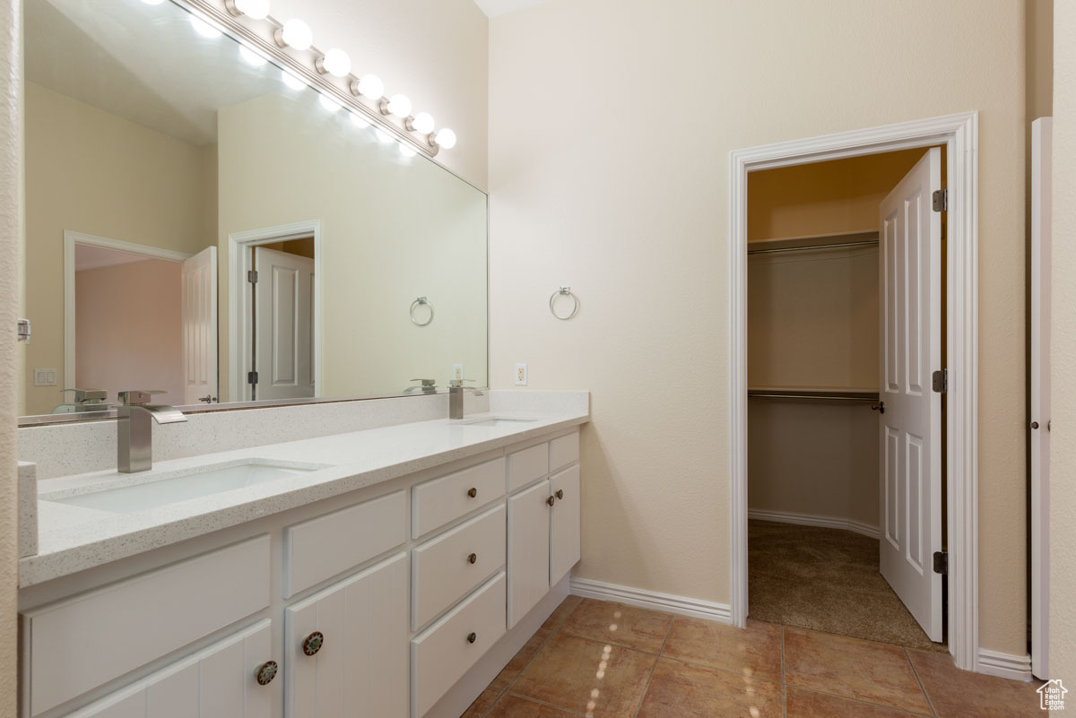 Bathroom with tile flooring and double sink vanity. this also has a built in adjustable make up mirror. Primary bedroom bath