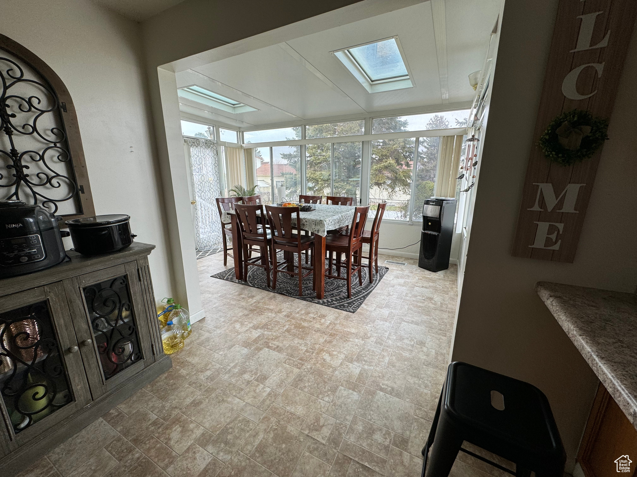 Tiled dining space featuring a skylight