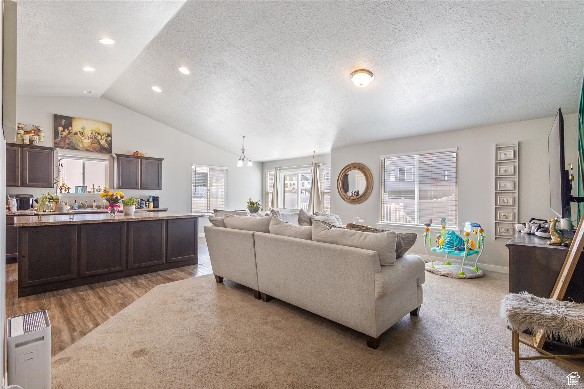 Living room featuring vaulted ceiling and carpet