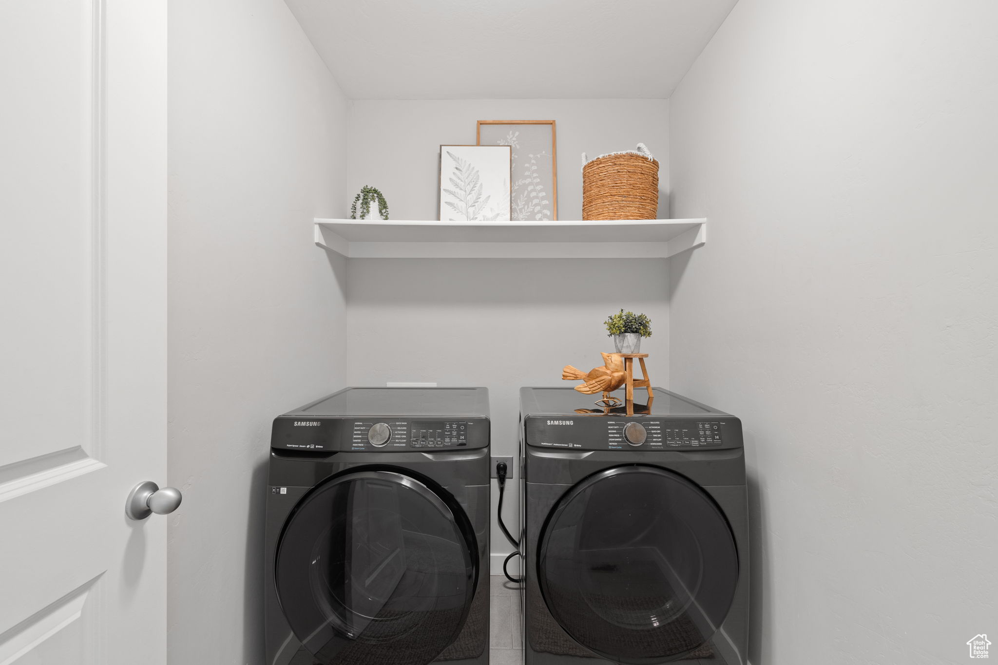 Clothes washing area featuring washer and dryer