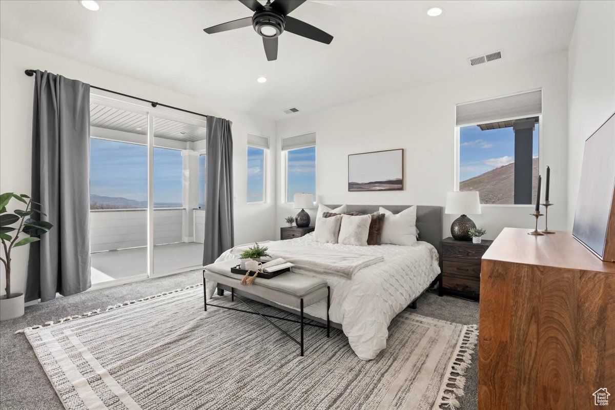 Bedroom featuring ceiling fan, carpet flooring, and access to exterior