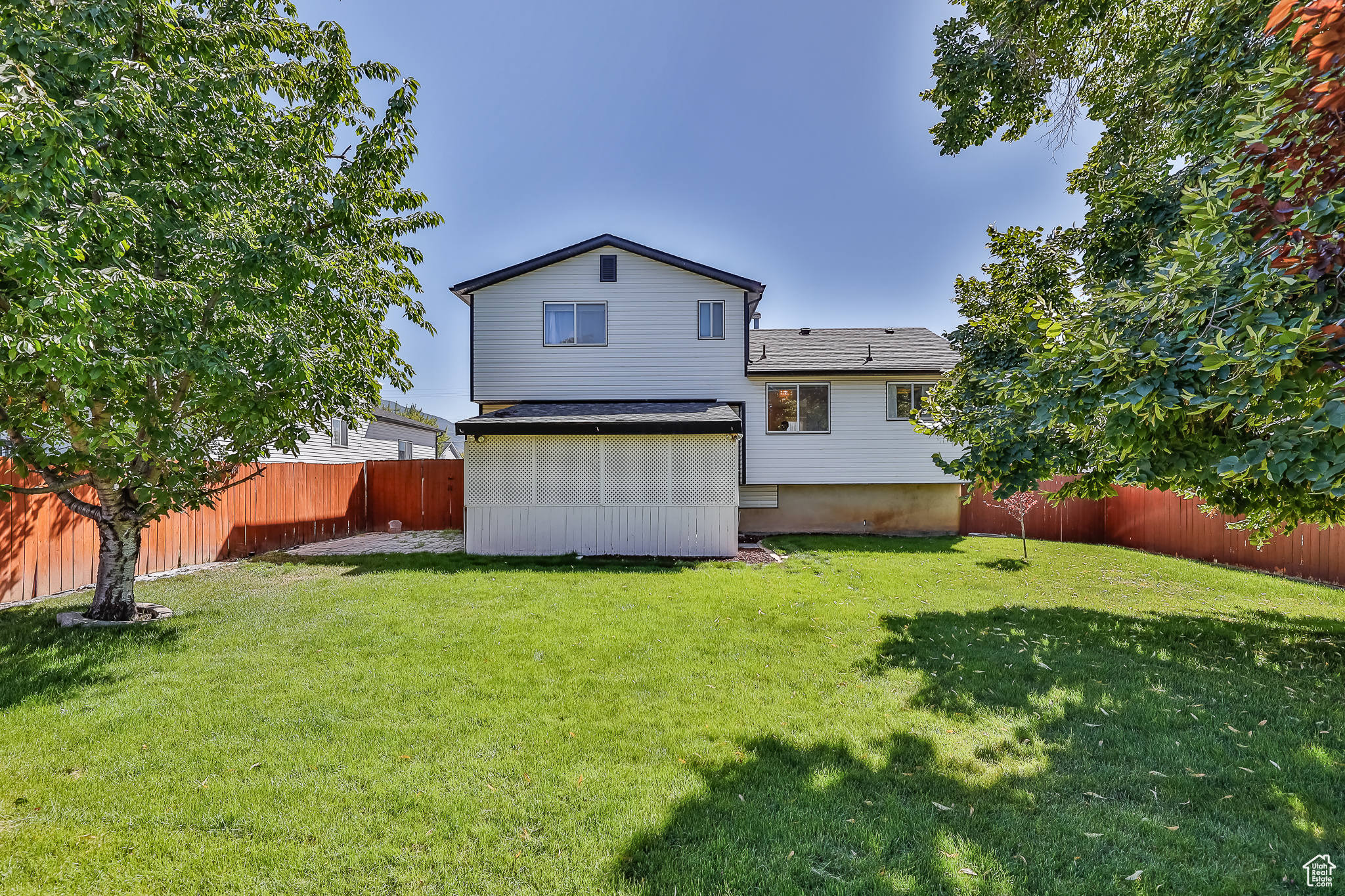 Back of house with a lawn