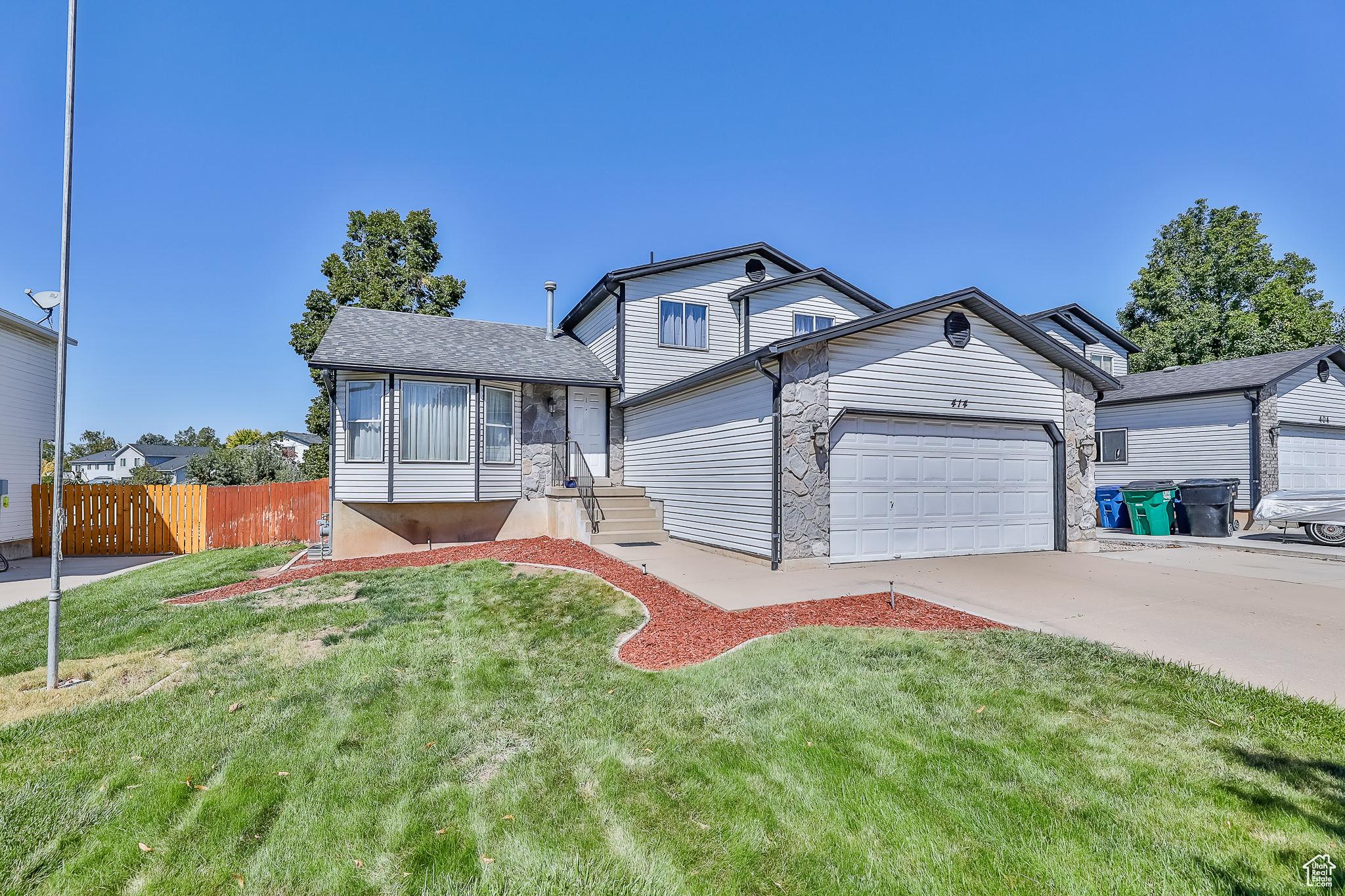 View of front of property featuring a garage and a front yard