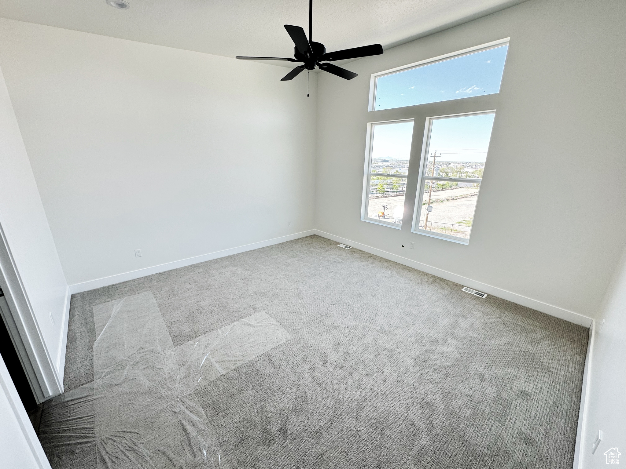 Master bedroom featuring ceiling fan and carpet flooring