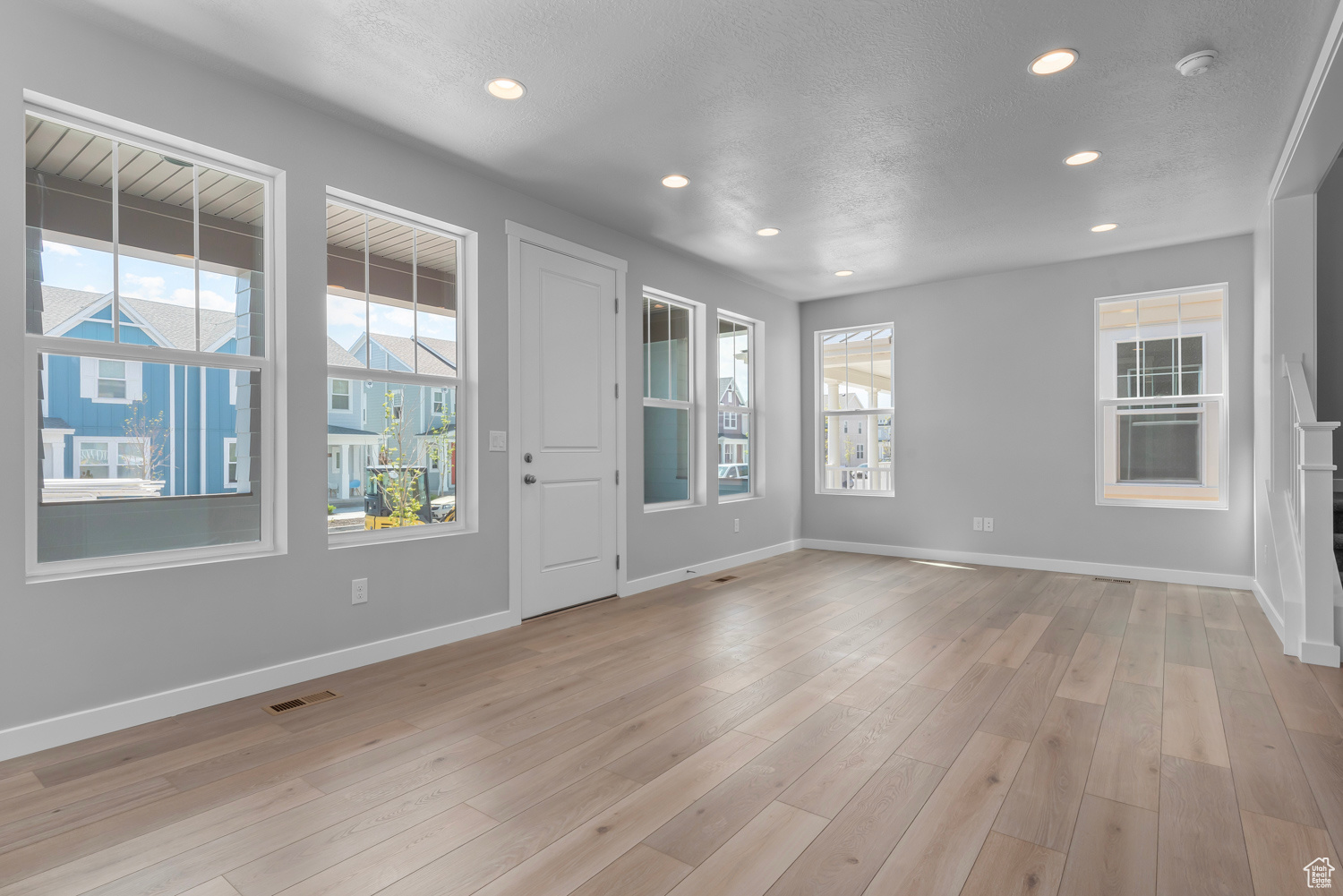 Interior space with a wealth of natural light and light hardwood / wood-style floors