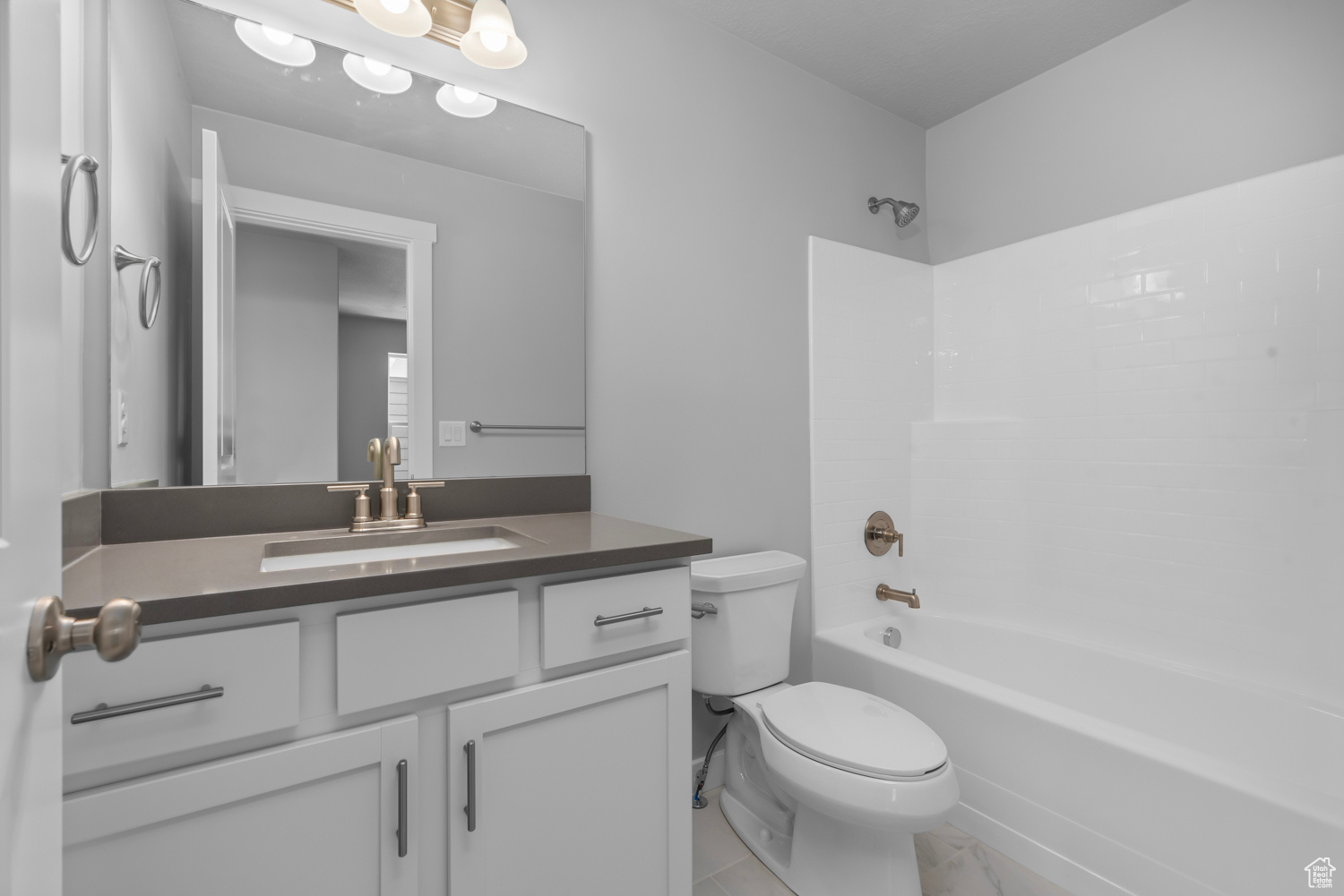 Full bathroom featuring tile floors, shower / washtub combination, toilet, and large vanity