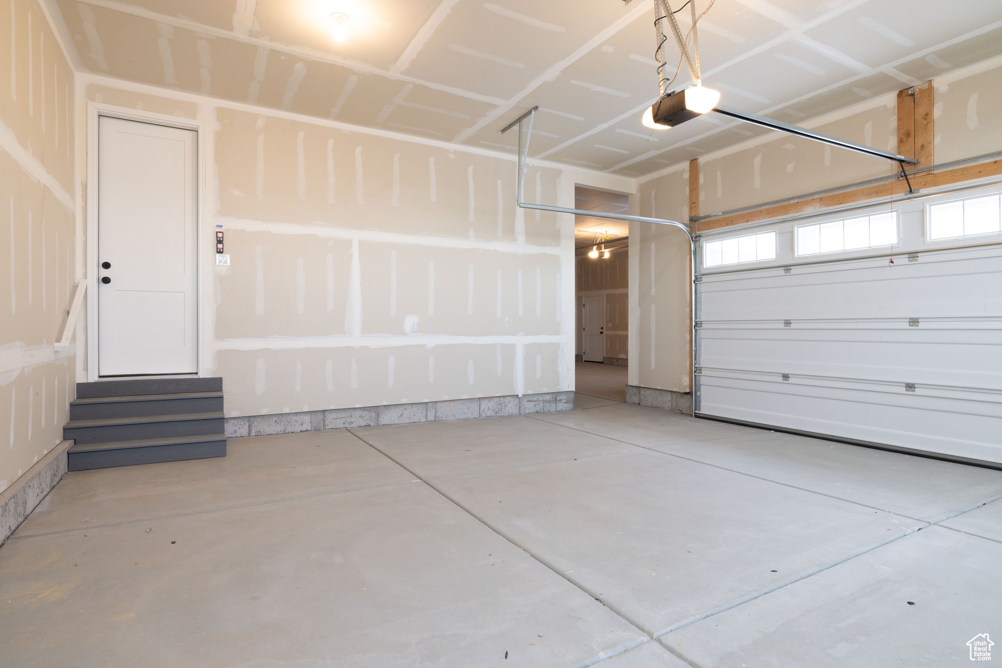 Garage featuring a garage door opener