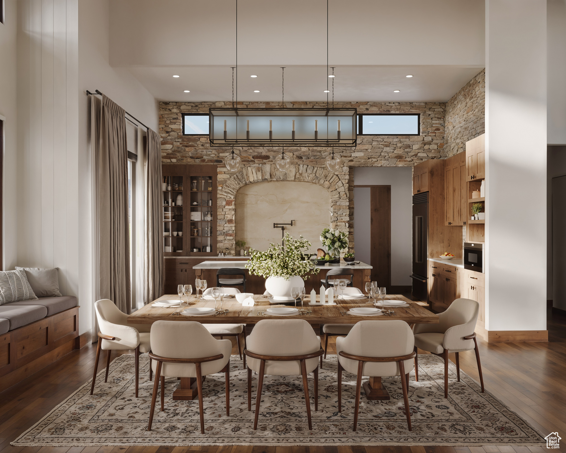 Dining space featuring a towering ceiling and hardwood / wood-style flooring