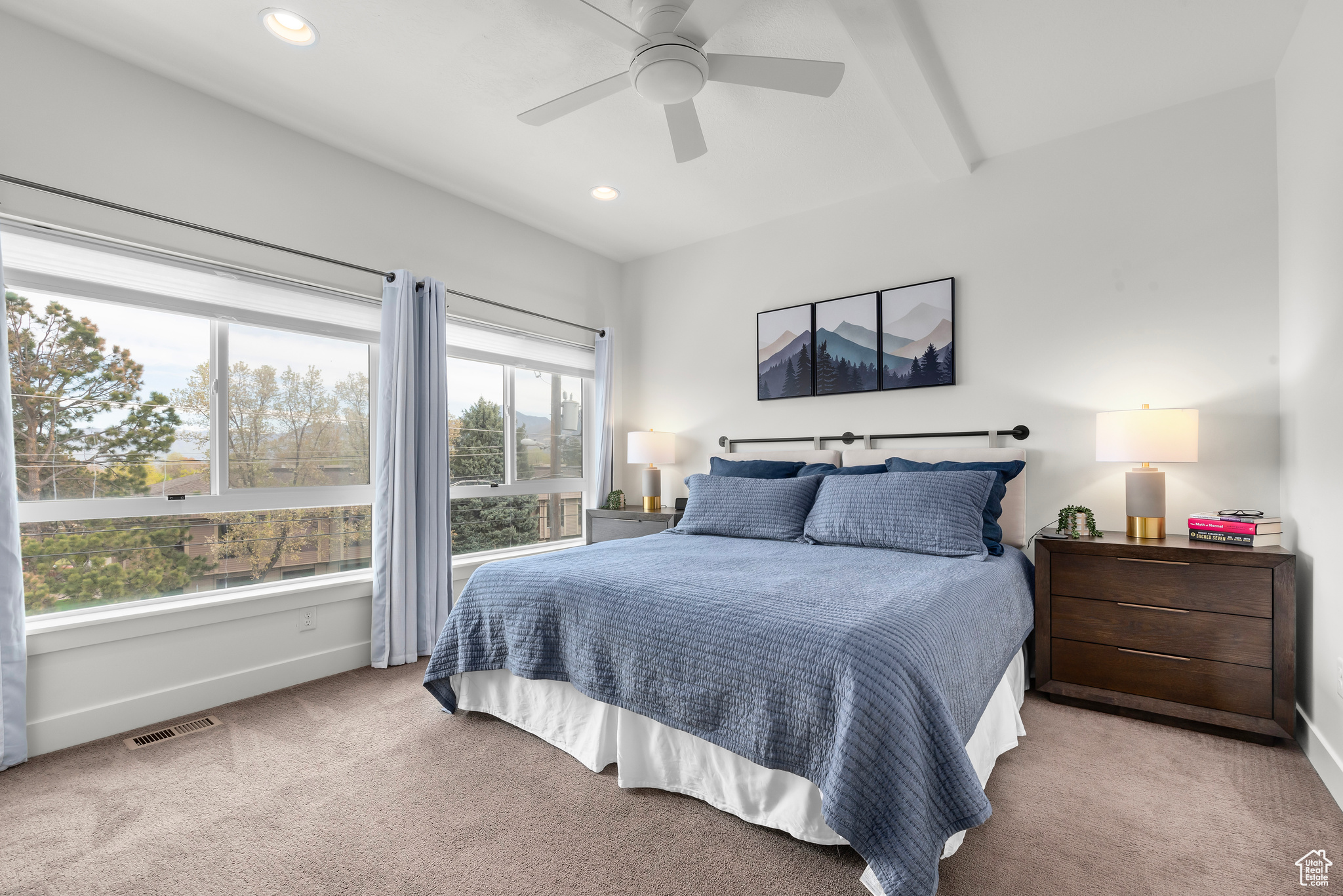 Owners bedroom featuring beam ceiling and ceiling fan
