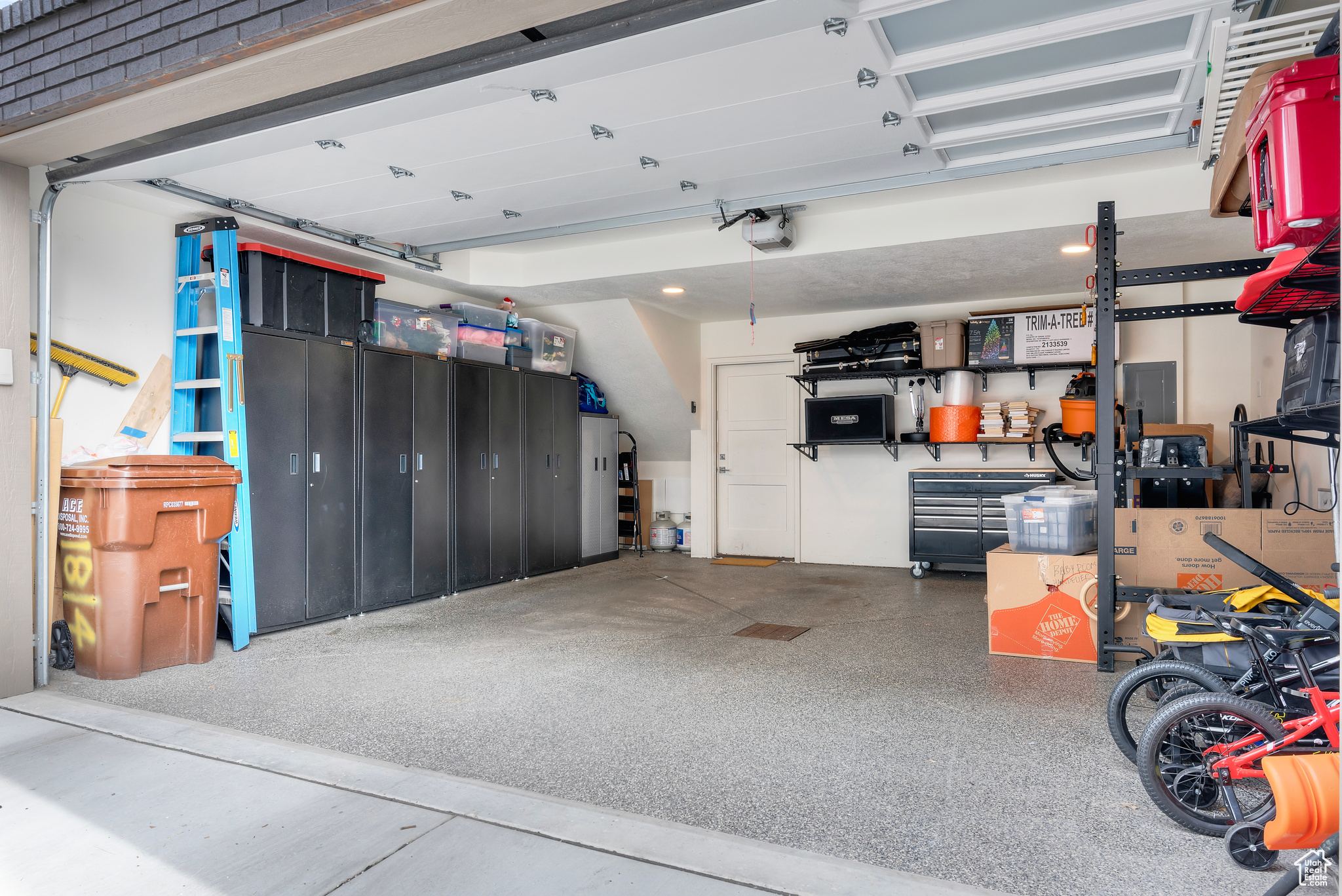 Garage featuring Epoxy coated floor and garage door opener