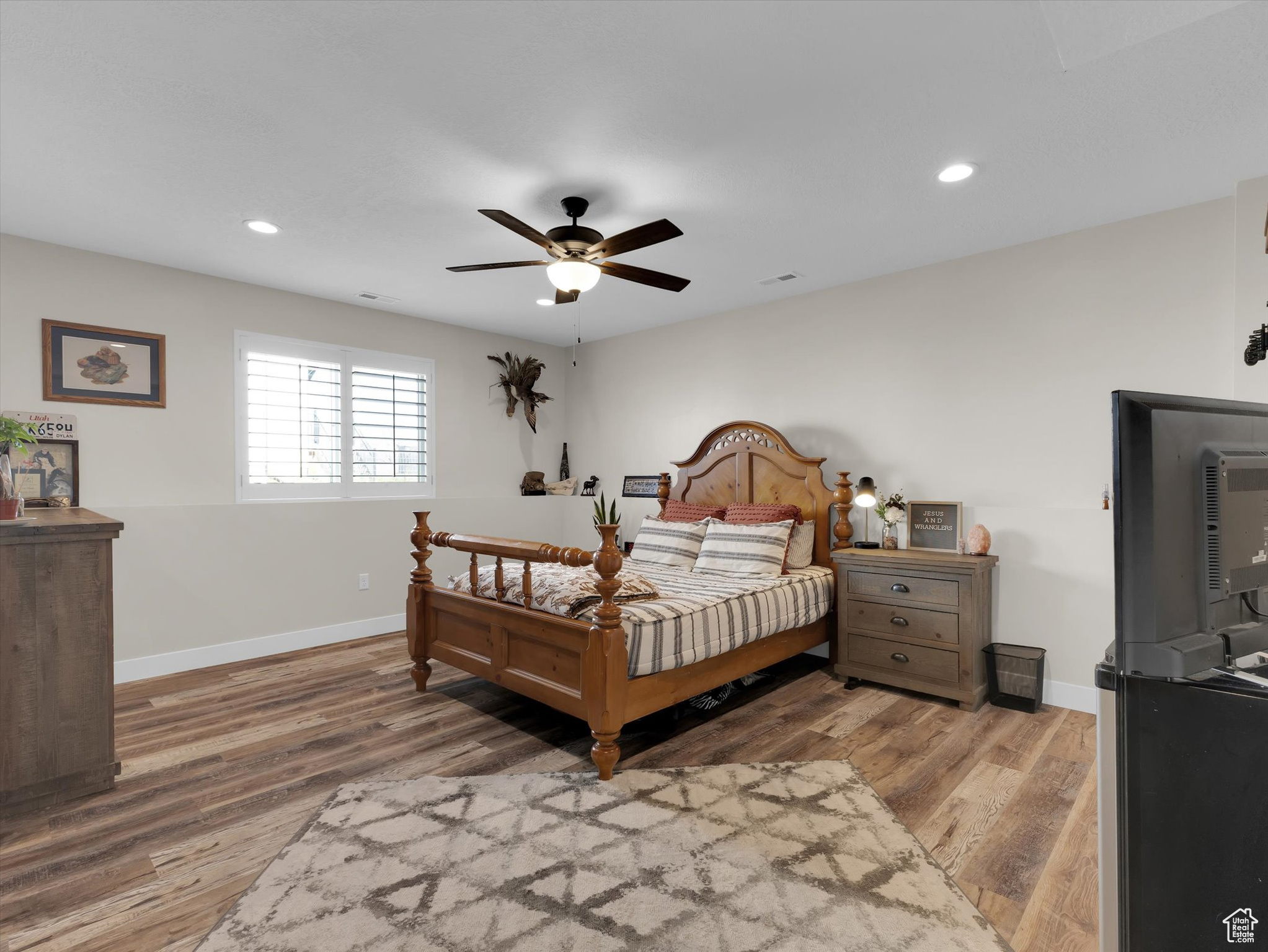 Bedroom #3 with ceiling fan and hardwood / wood-style flooring